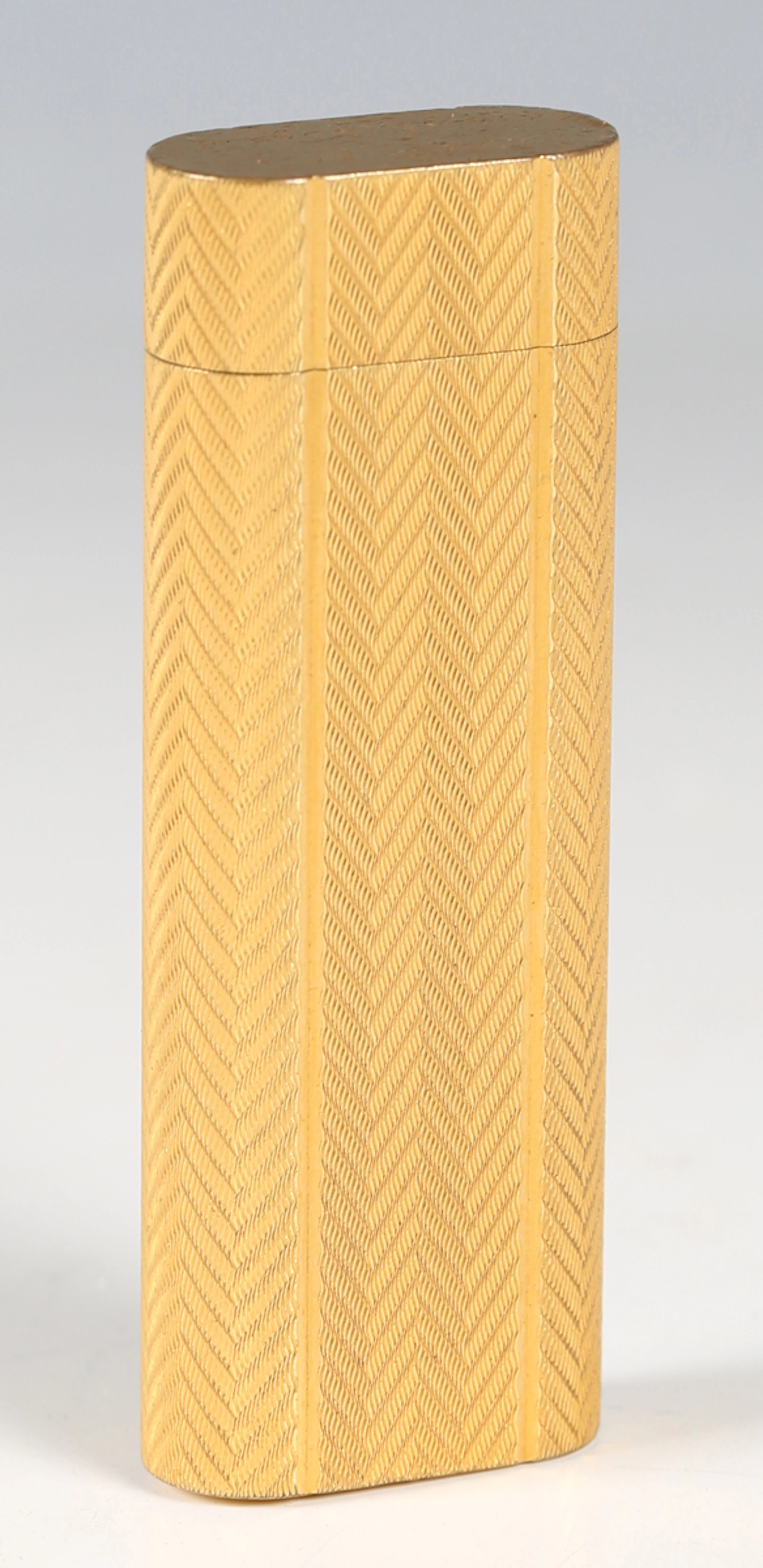 A Cartier gold plated pocket lighter, bearing Arabic inscription to