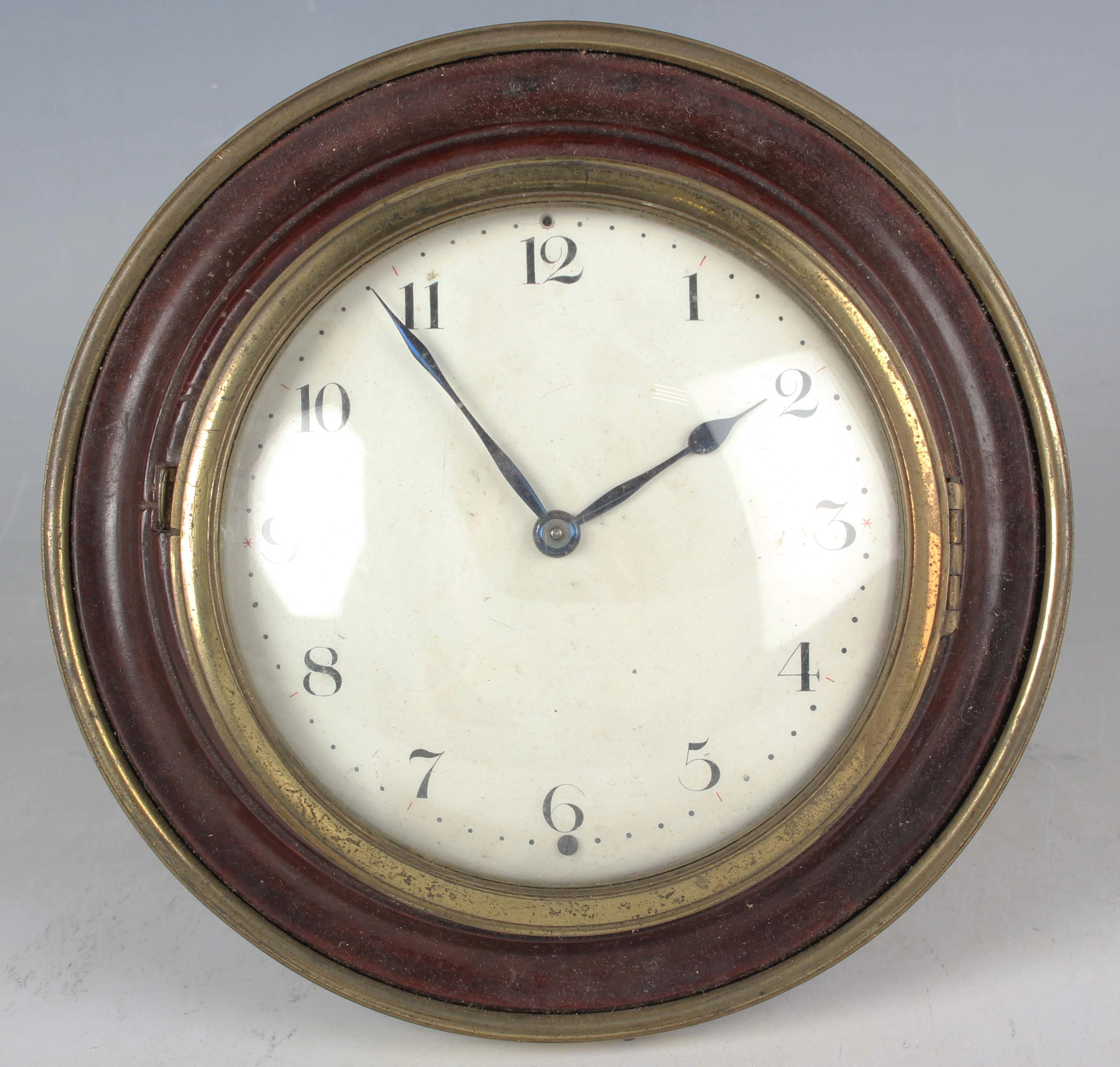 A 19th century brass mahogany circular cased sedan style clock timepiece