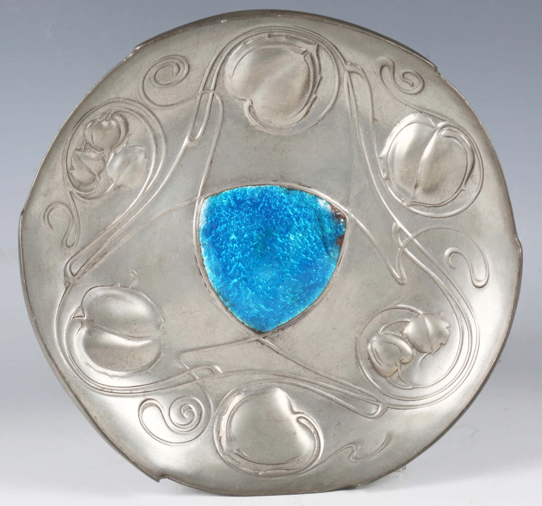A Liberty & Co 'Tudric' pewter and enamel circular dish, designed