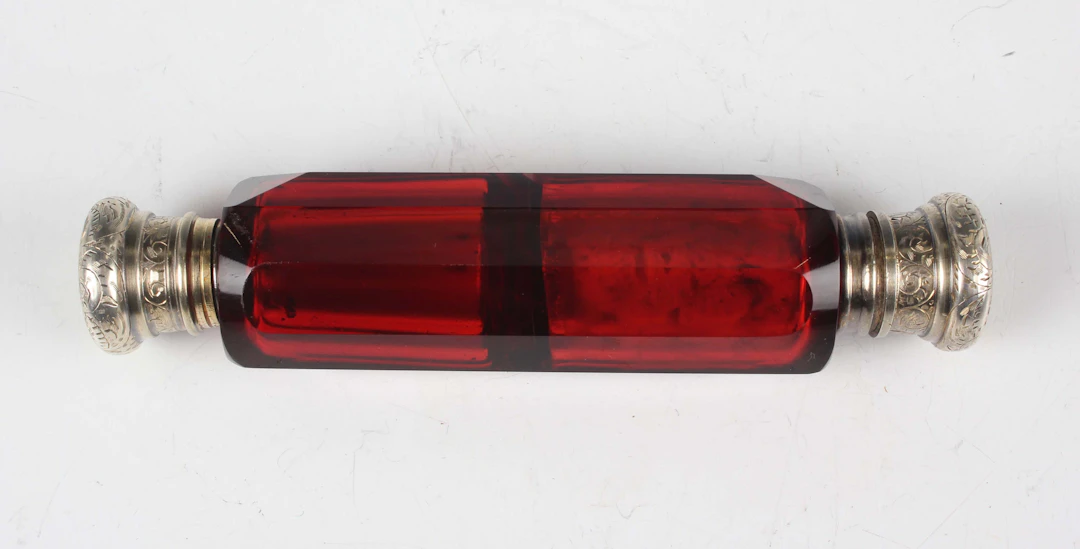 A Victorian silver mounted cut ruby glass double-ended scent bottle