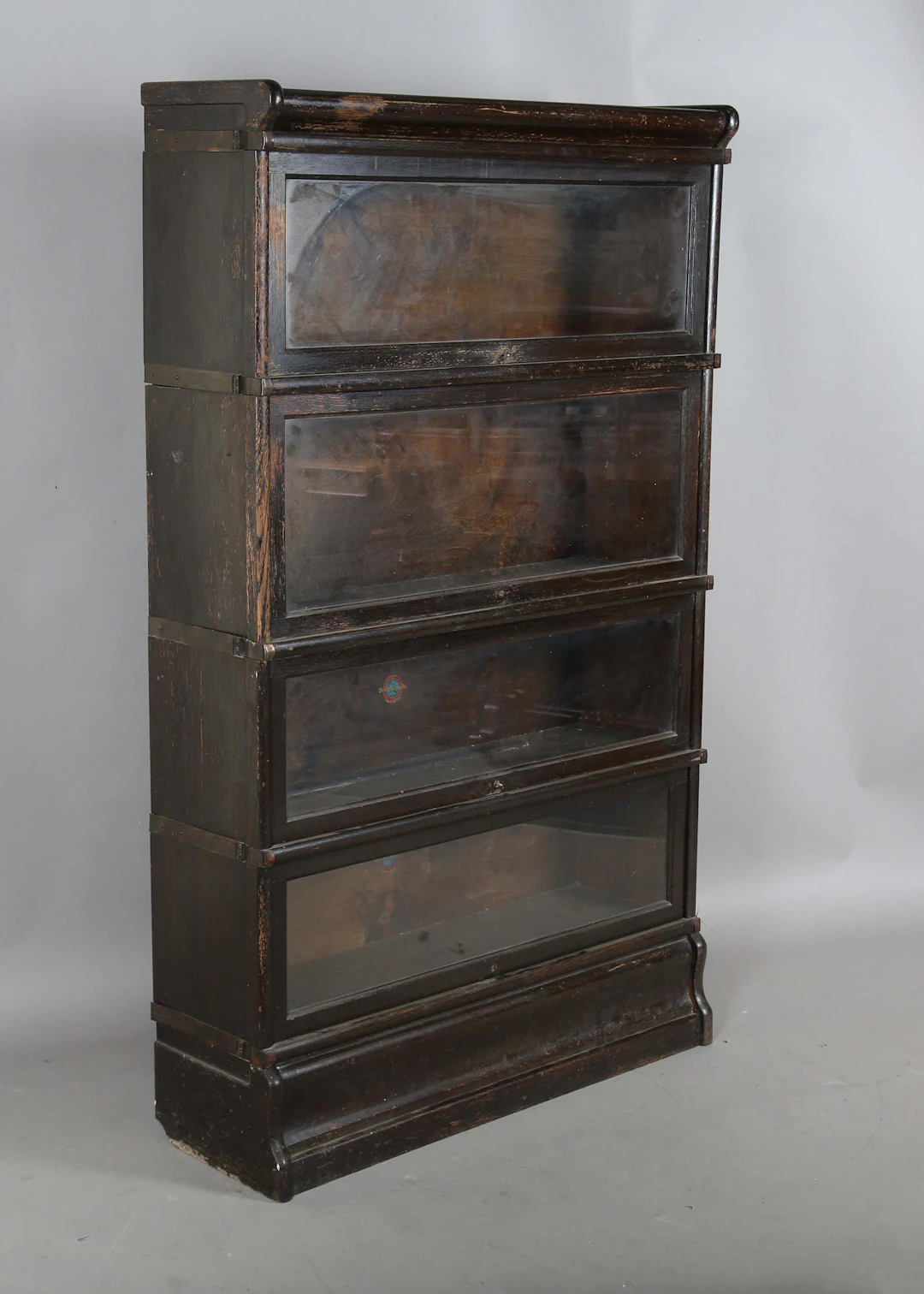 An early 20th century stained oak four-section Globe Wernicke bookcase