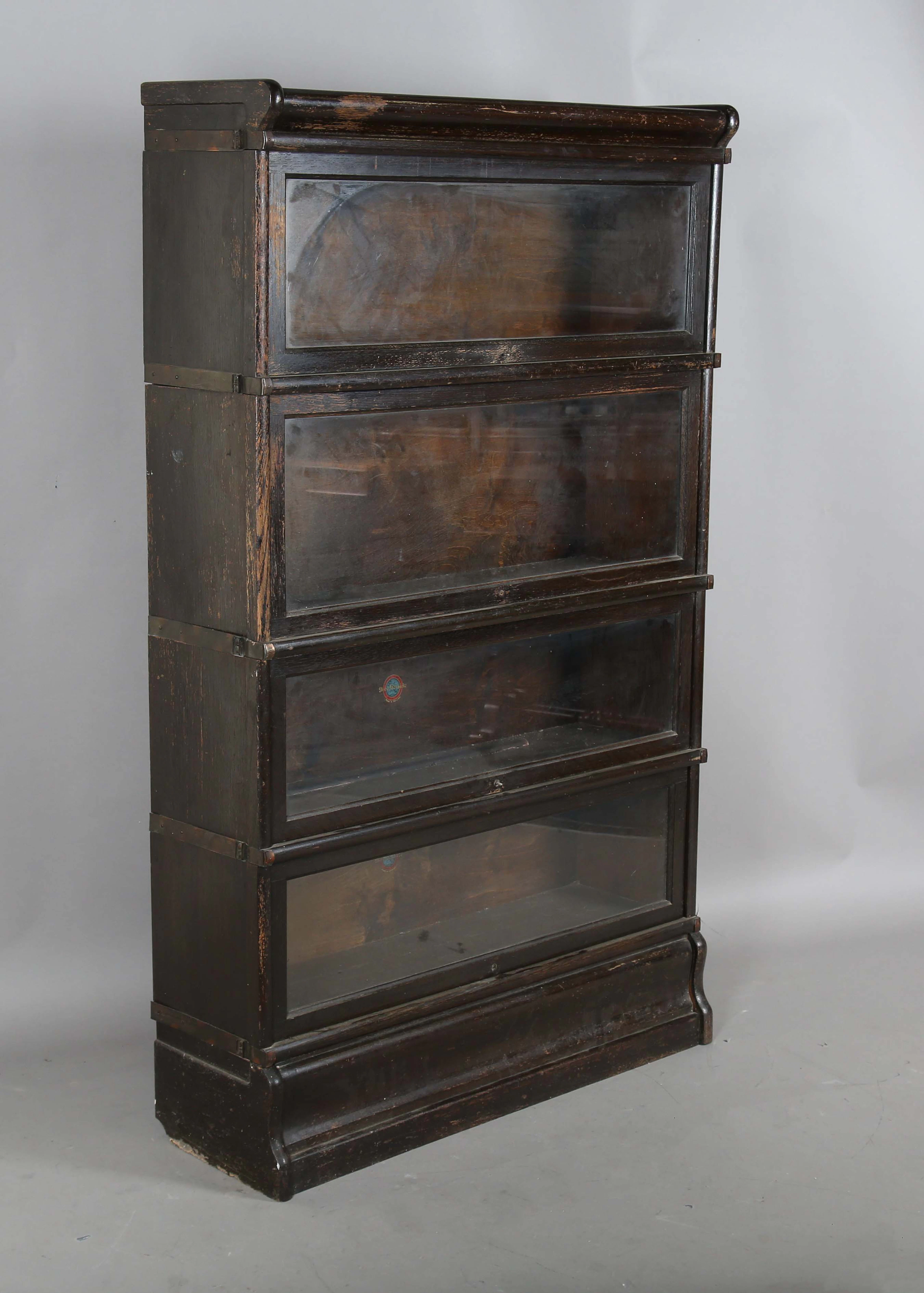 An early 20th century stained oak four-section Globe Wernicke bookcase