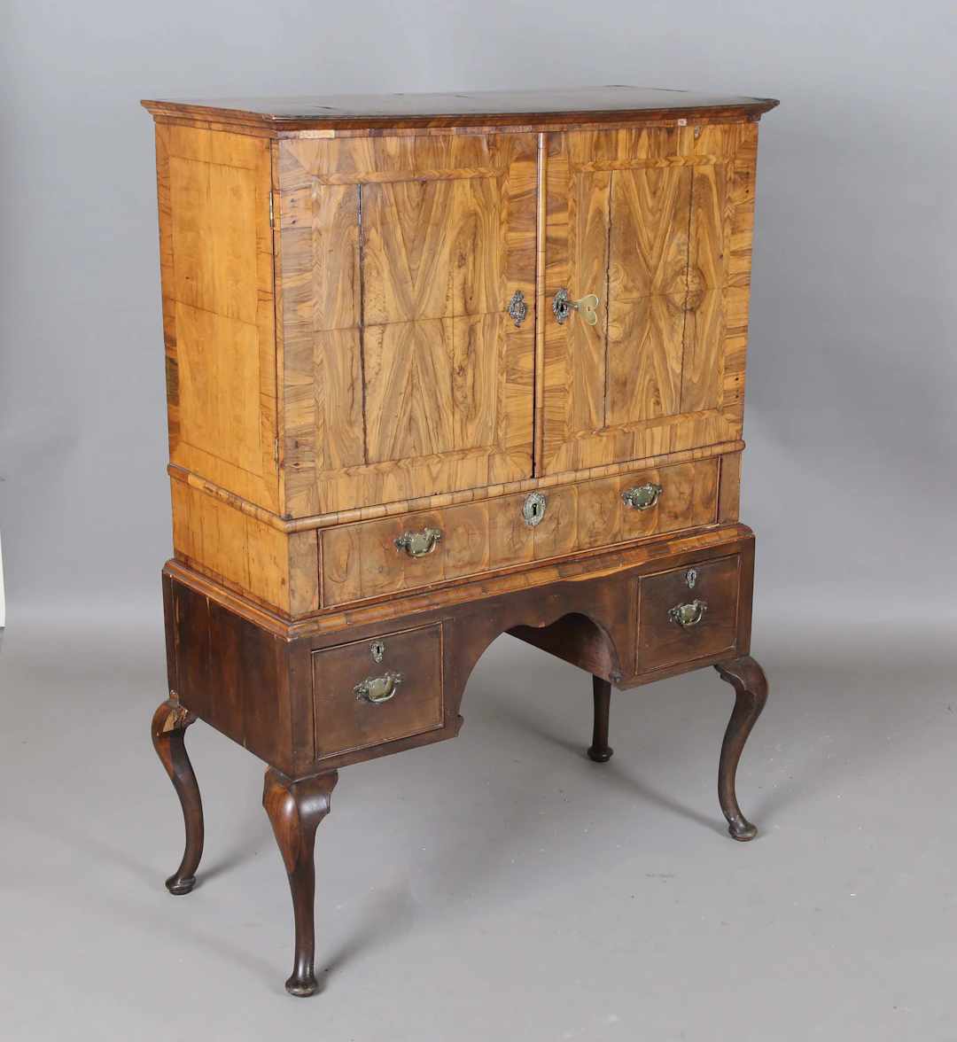 An early 18th century walnut collector's cabinet, the two doors enclosing