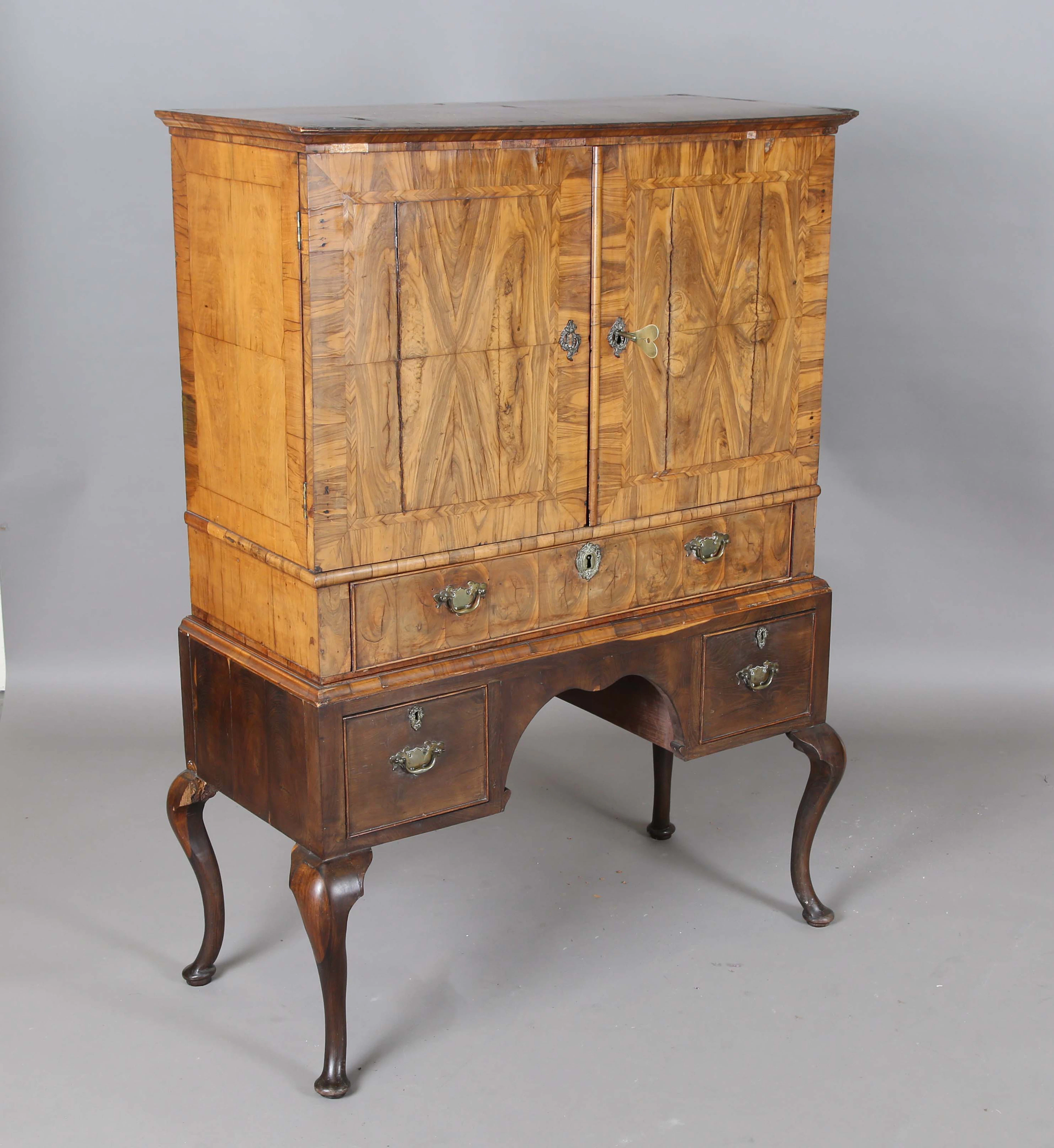 An early 18th century walnut collector's cabinet, the two doors enclosing