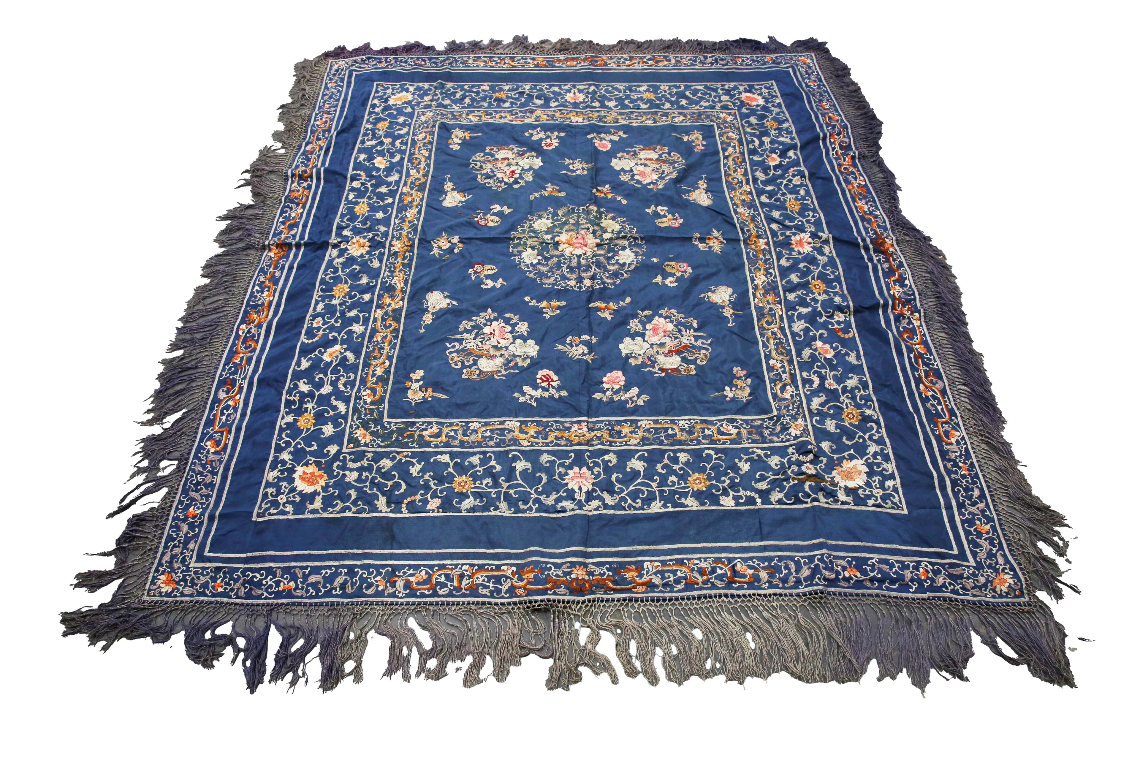 A Chinese blue silk and embroidered table cover, finely worked in