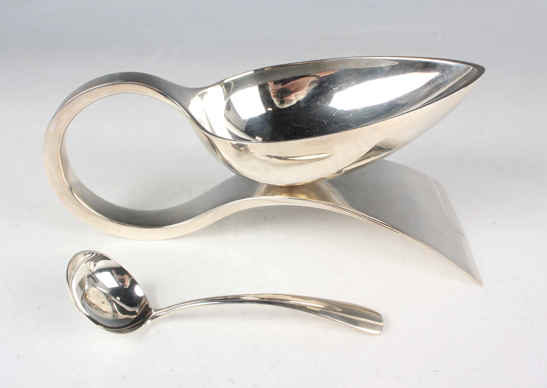 A Modernist silver sauceboat and ladle, modelled as a large serving