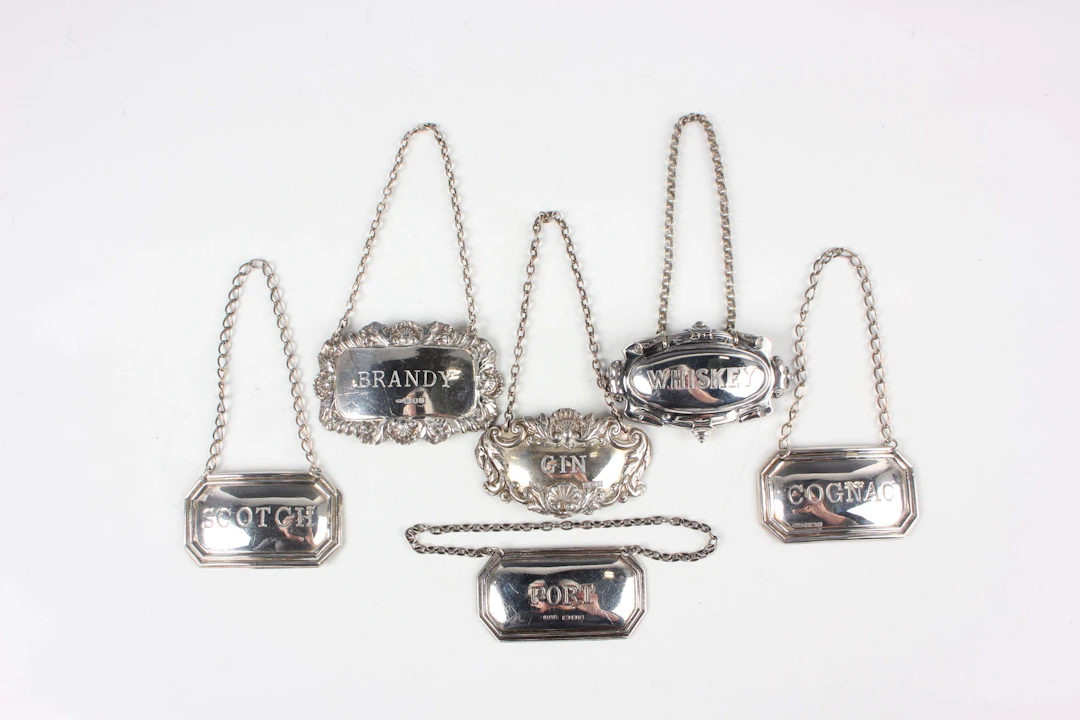 A pair of Elizabeth II silver decanter labels, comprising 'Scotch'