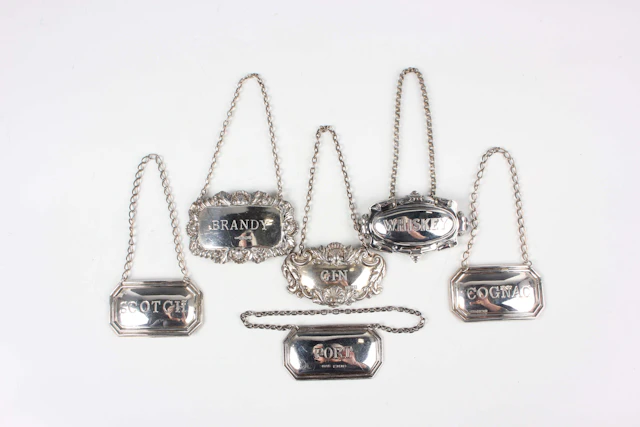 A pair of Elizabeth II silver decanter labels, comprising 'Scotch'