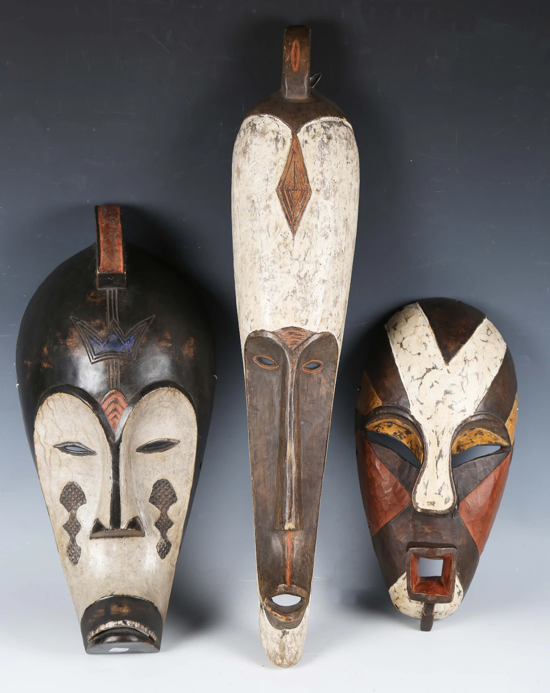 A group of three decorative carved and painted wooden African Fang