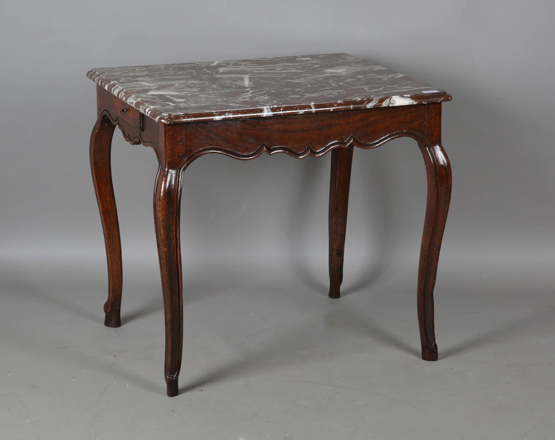 An 18th century French provincial walnut occasional table with a later
