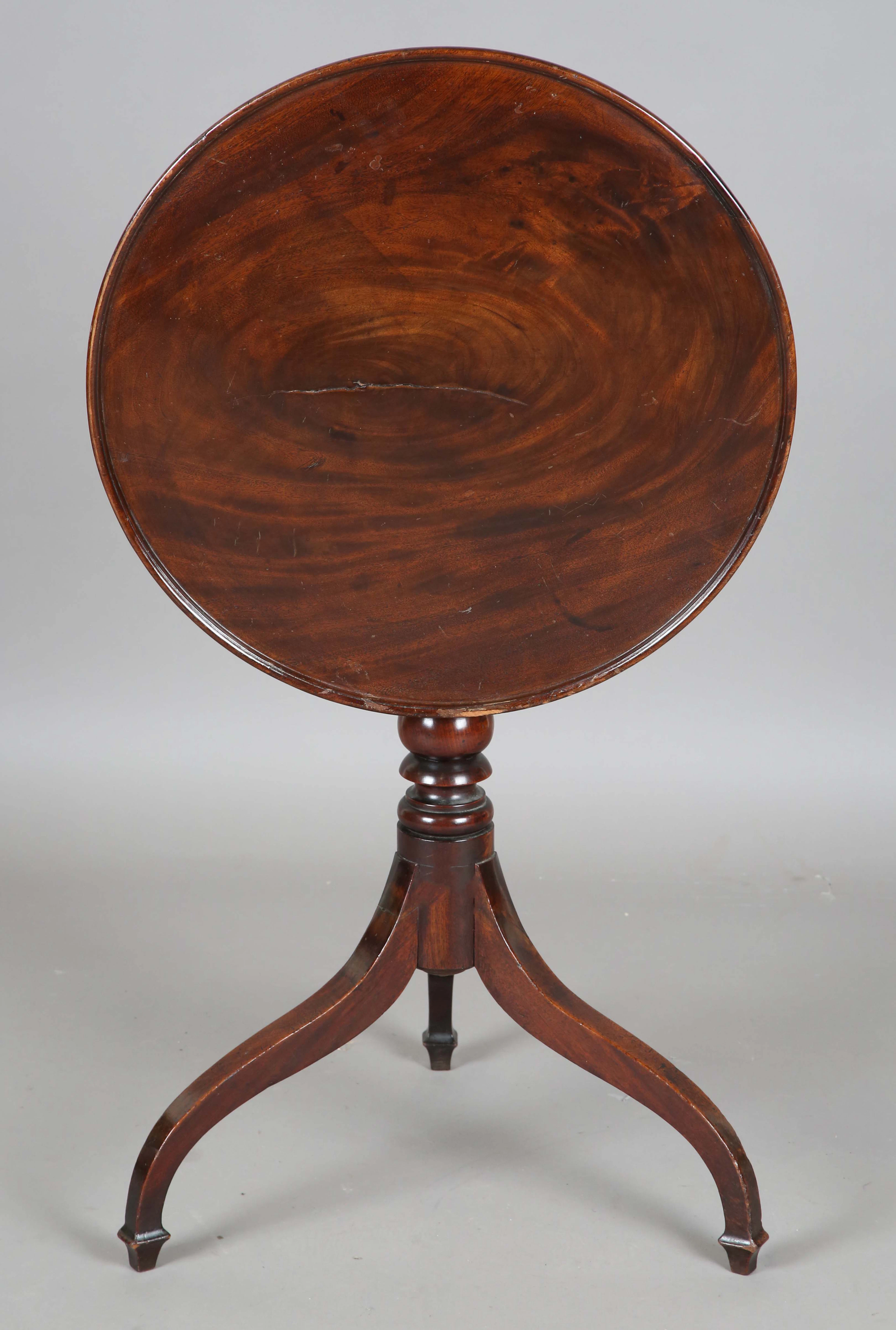 A George III mahogany circular tip-top wine table, the dished top