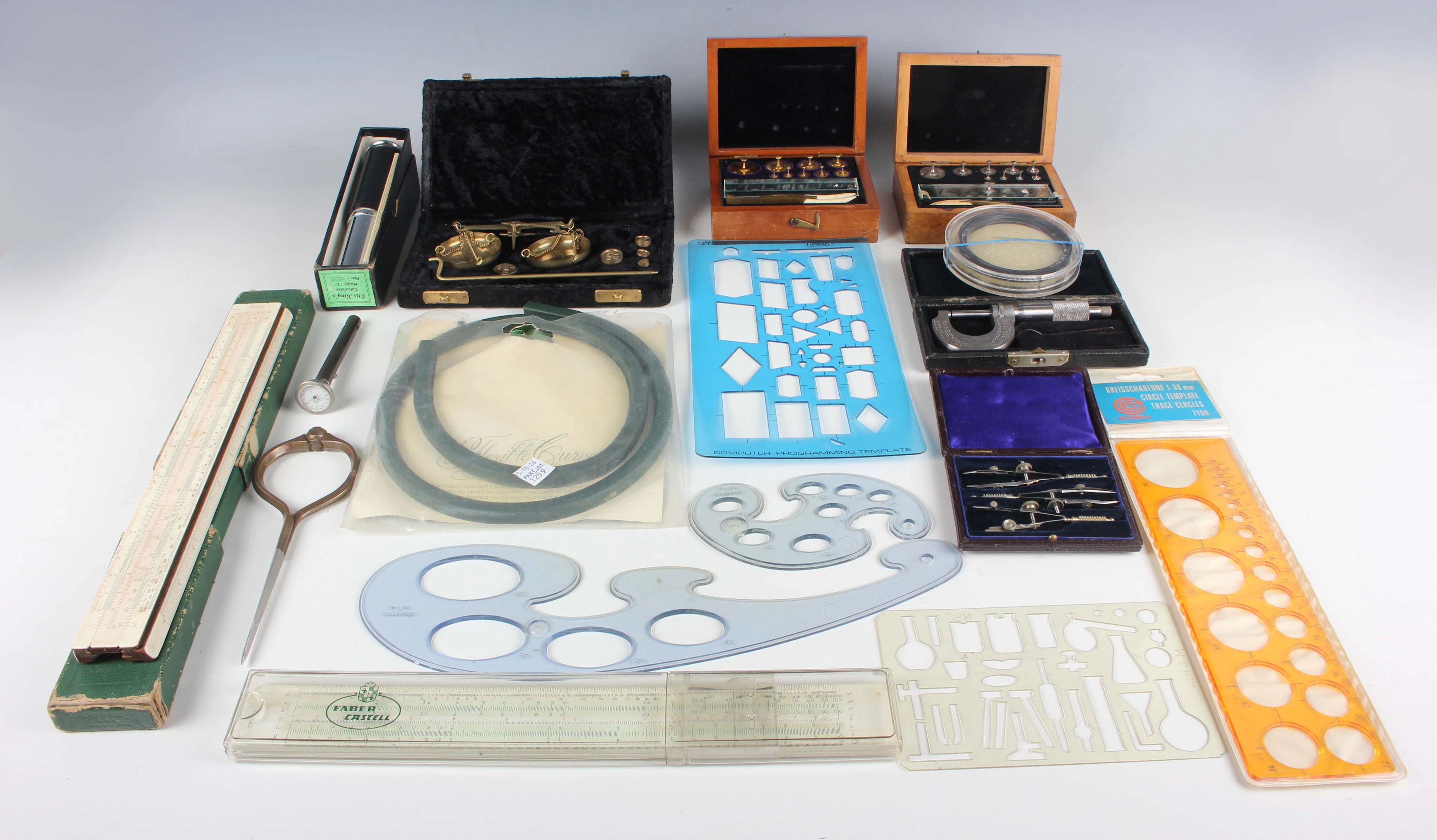 A small group of scientific instruments, including an Otis Kings calculator