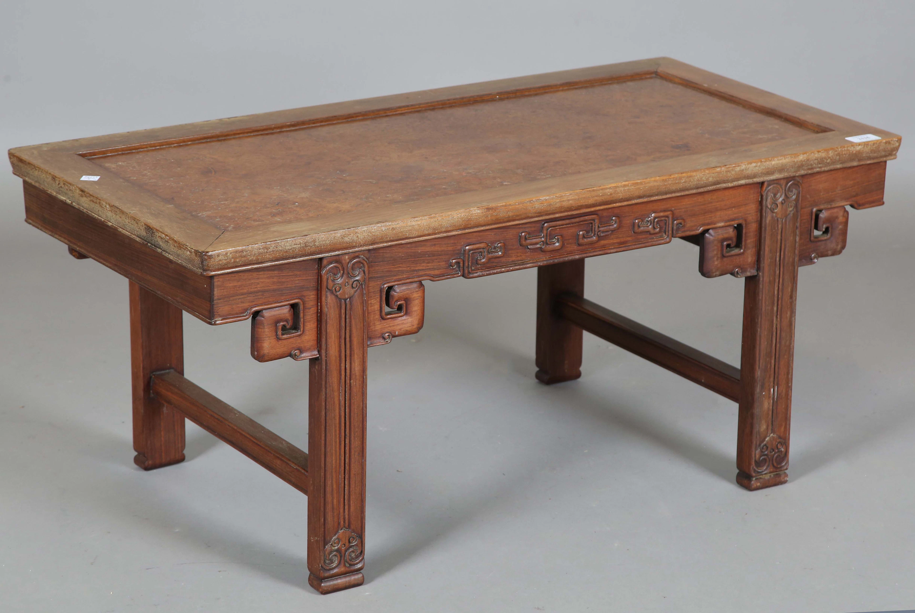 A Chinese hardwood low rectangular table, the top inset with a burr