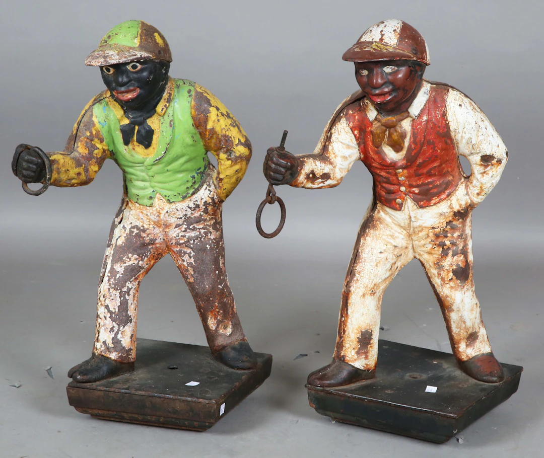 A pair of early 20th century painted cast iron horse tethering posts