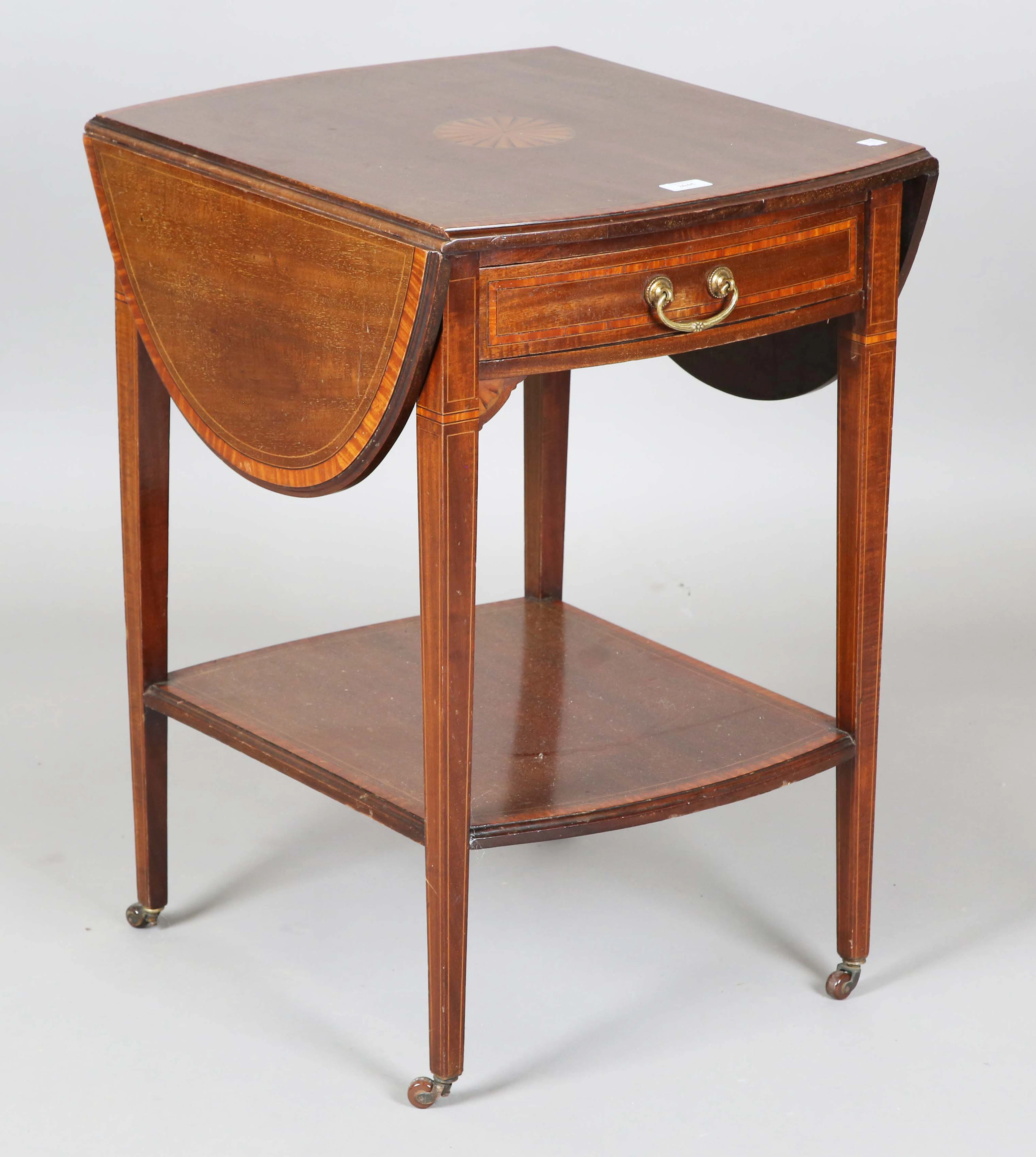 An Edwardian mahogany oval Pembroke table with an inlaid fan patera