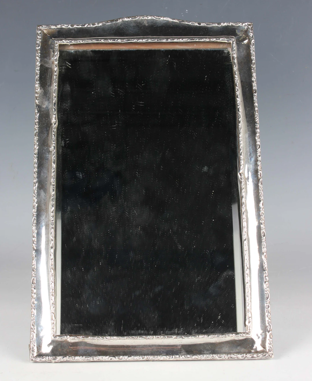 A George V silver rectangular dressing table mirror with plain band