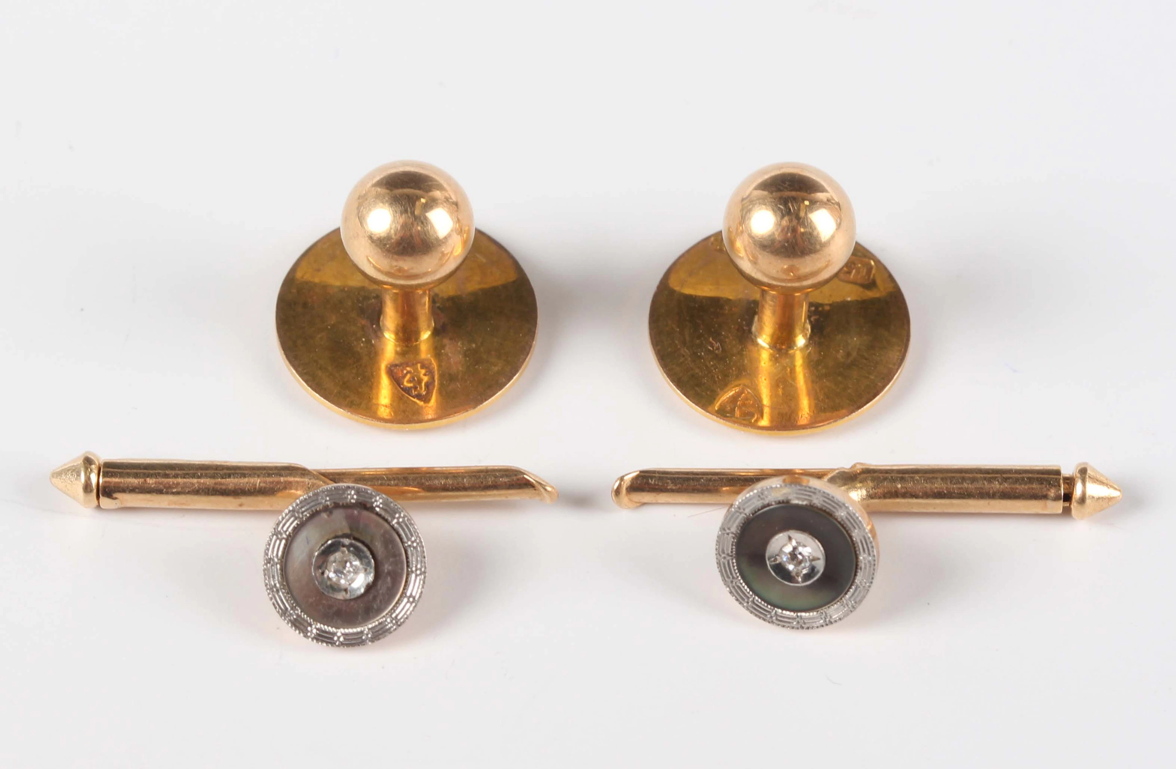 A pair of 15ct gold dress studs, weight 2.2g, and a pair of gold