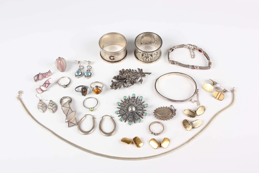 A group of silver jewellery, comprising a marcasite floral spray brooch
