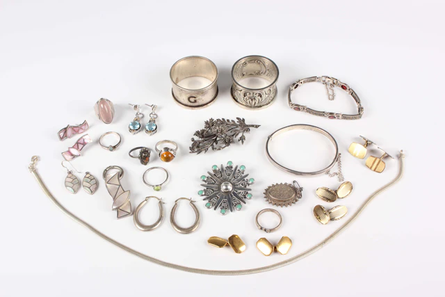 A group of silver jewellery, comprising a marcasite floral spray brooch