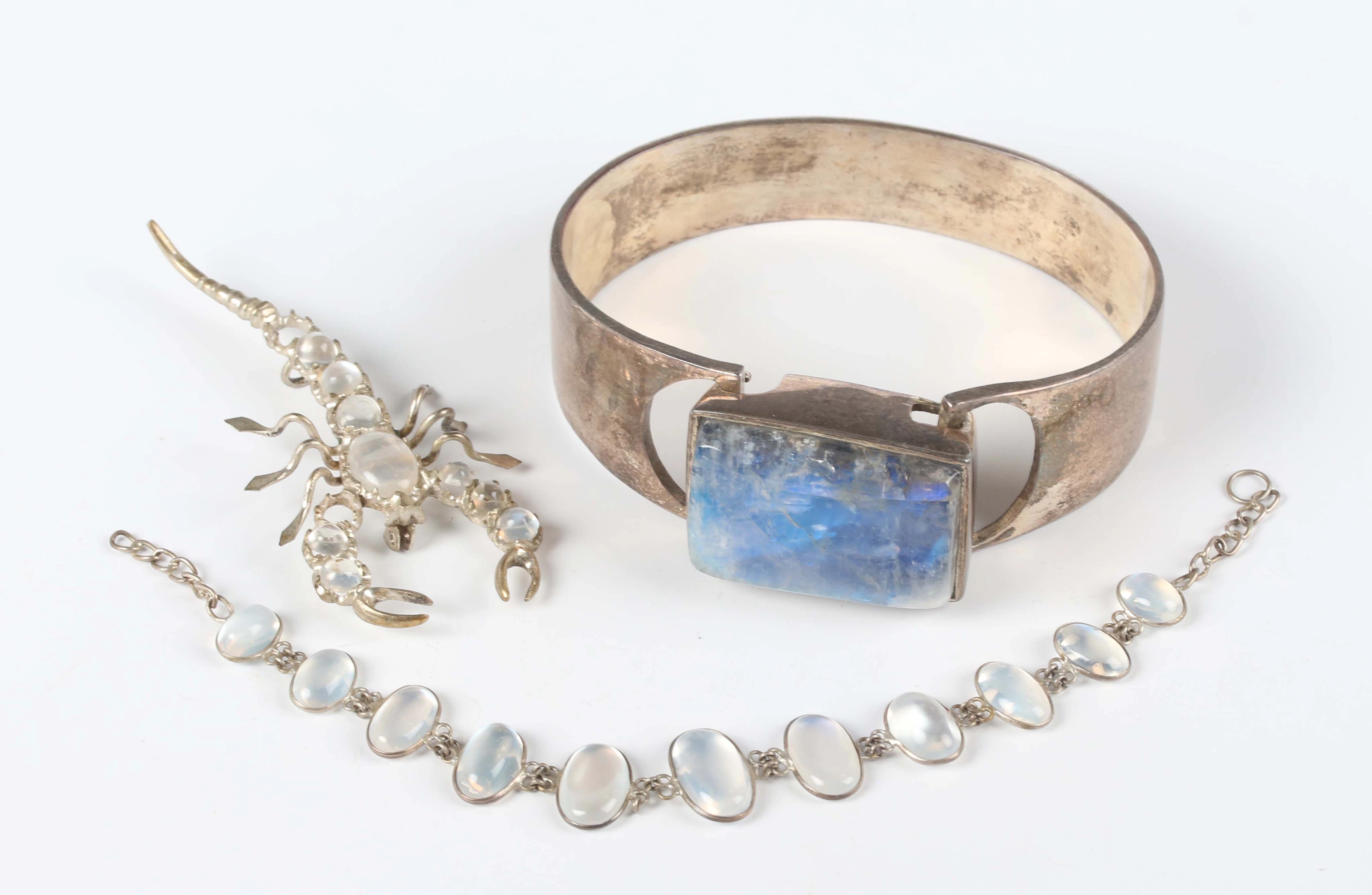 A white metal and labradorite oval sprung bangle, unmarked, inside