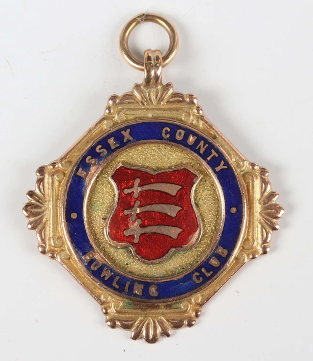 A 9ct gold and polychrome enamelled presentation medal, the front