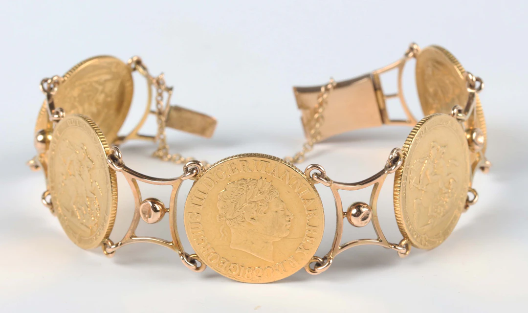 A gold bracelet, mounted with four George III sovereigns 1820 and