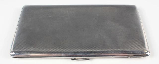 A George V silver rectangular cigarette case with engine turned decoration