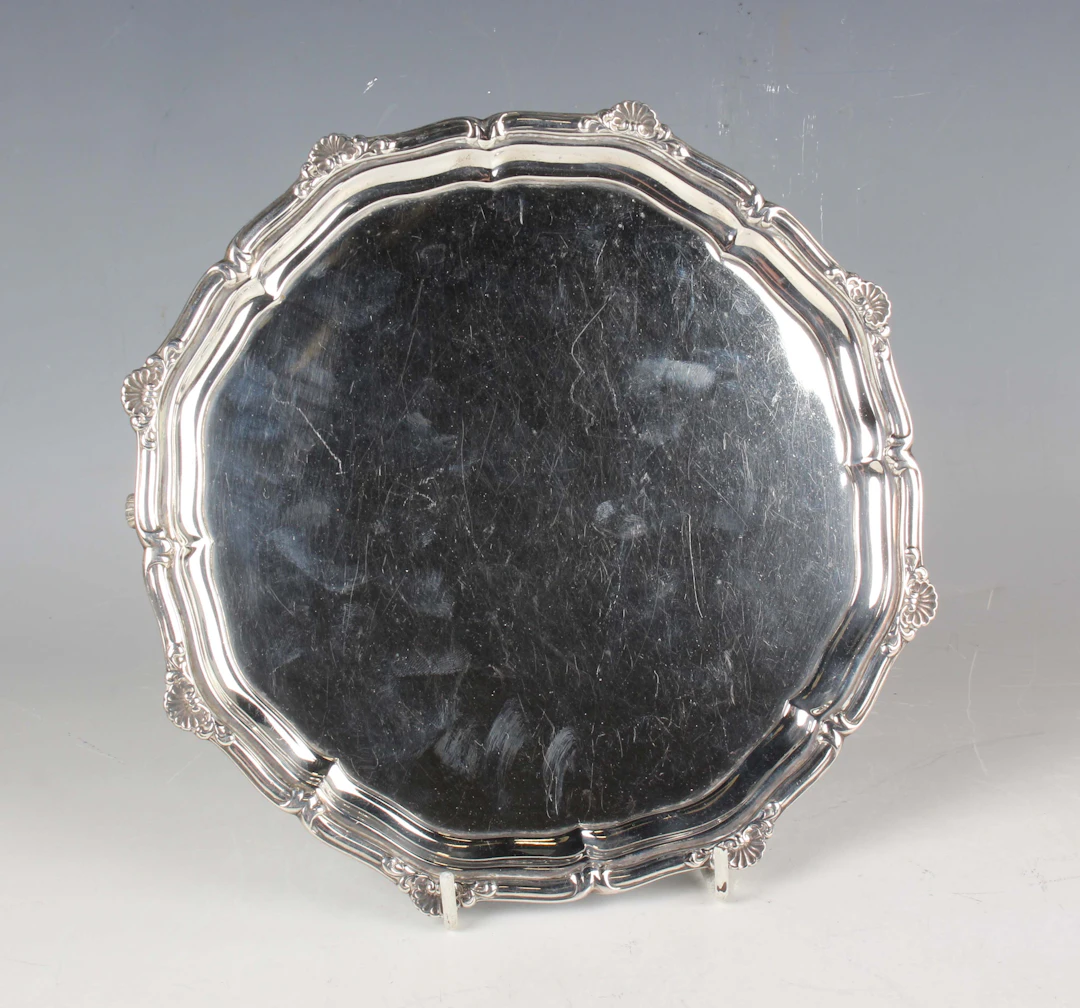 A George VI silver circular card salver with cast scallop shell rim