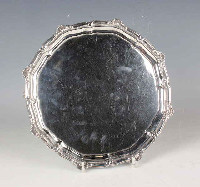 A George VI silver circular card salver with cast scallop shell rim