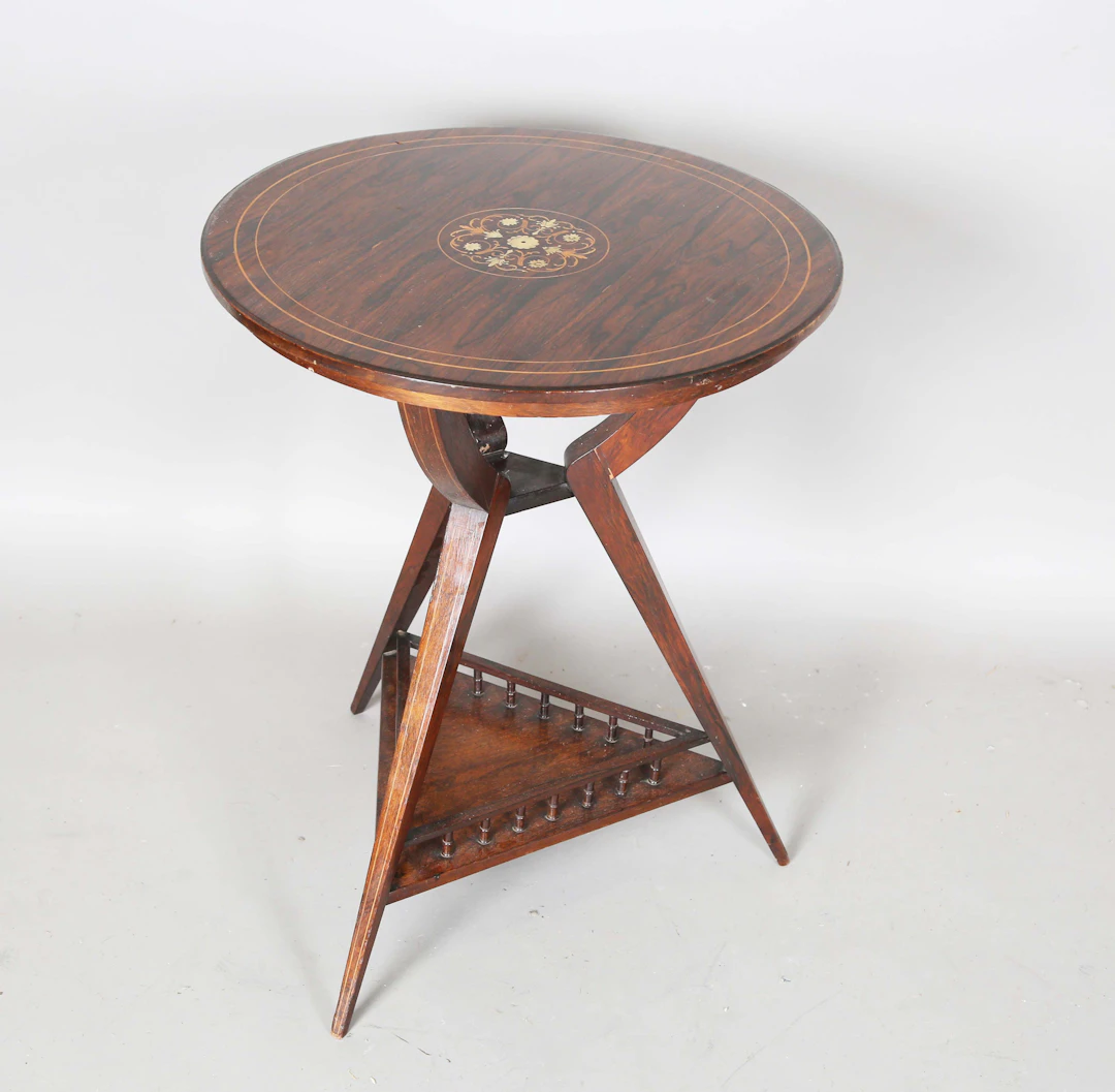 A late Victorian Aesthetic Movement rosewood and foliate inlaid circular