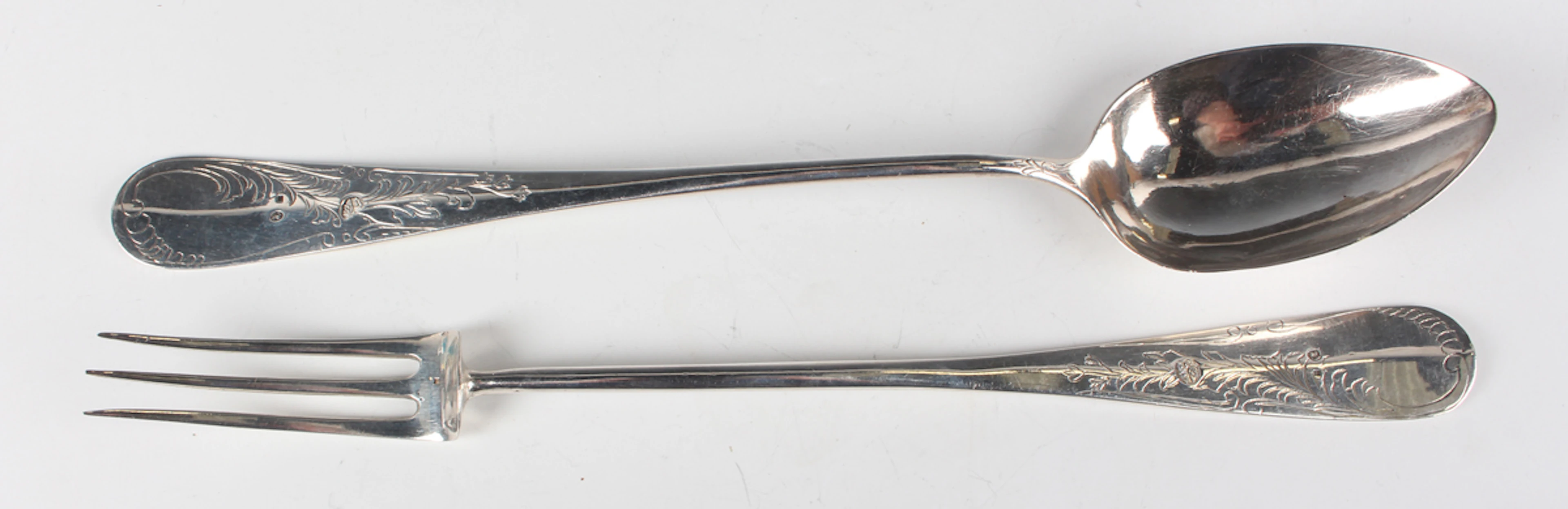 A Turkish silver serving spoon and matching fork, each long tapering