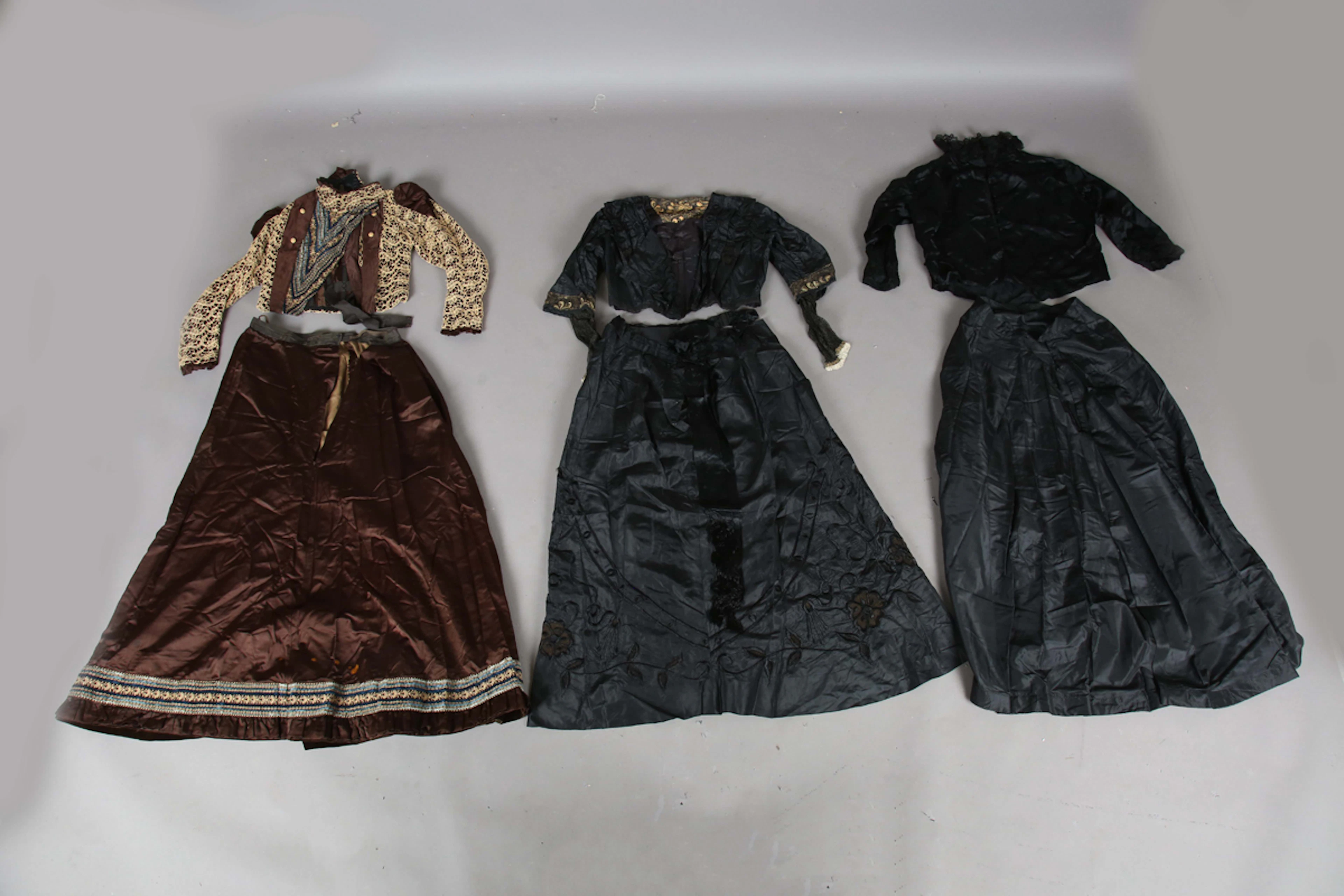 A collection of mainly Victorian clothing, including a brown silk