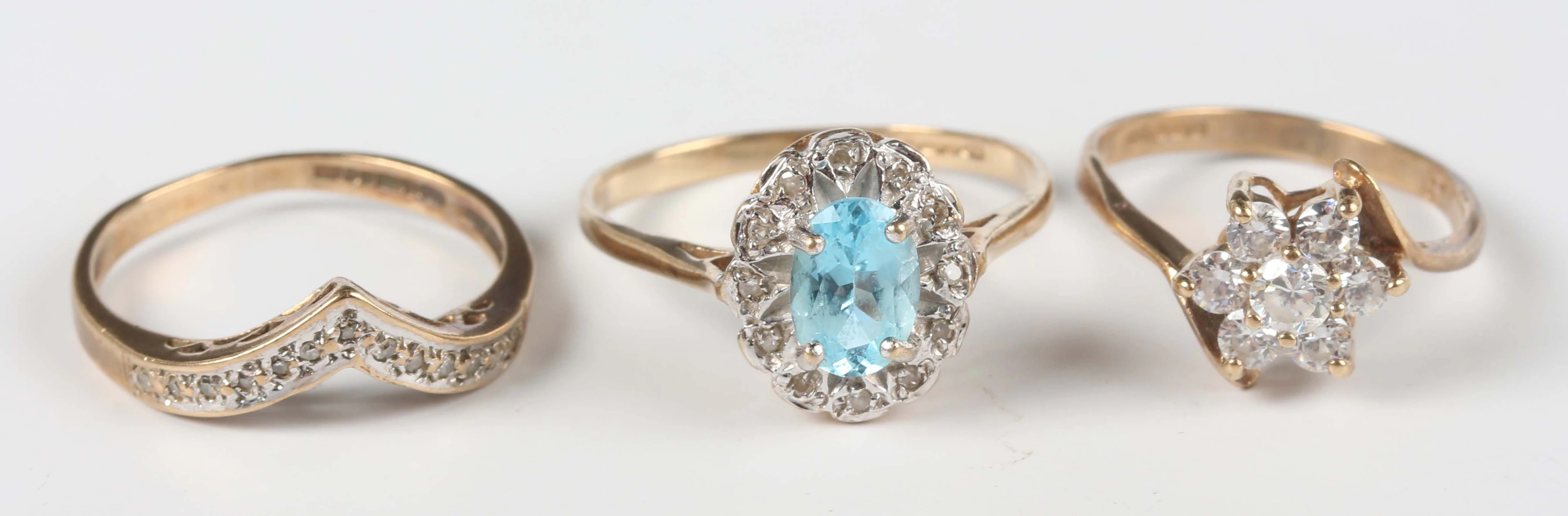 A 9ct gold, oval cut blue topaz and diamond cluster ring, ring size
