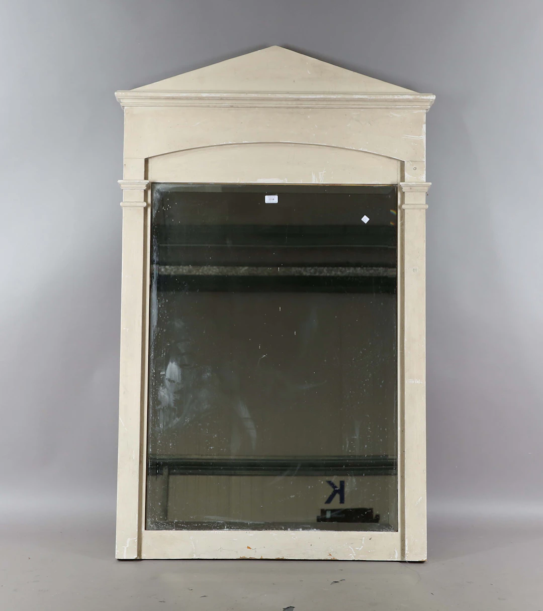 A modern white painted wall mirror with an arched pediment, height