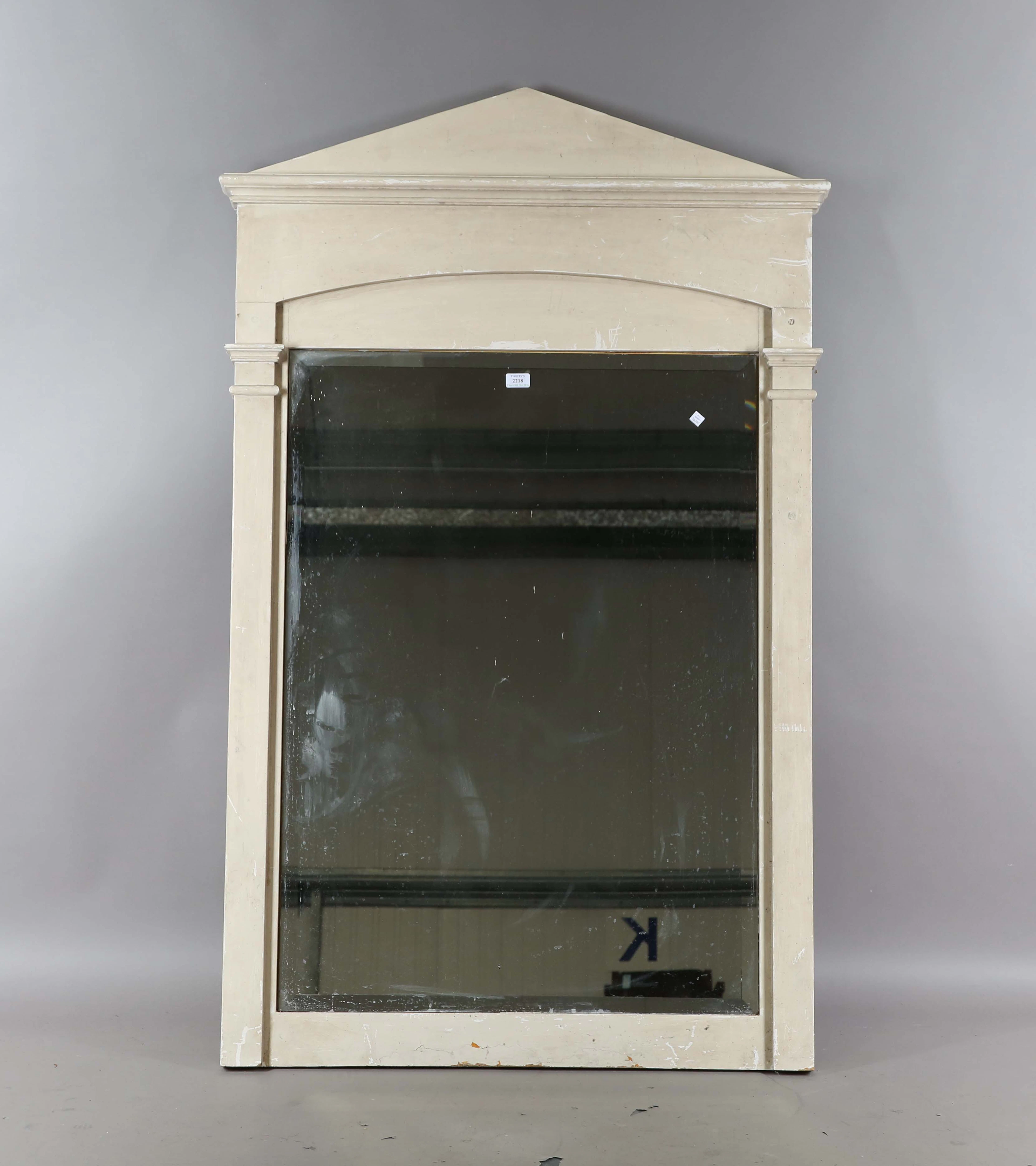 A modern white painted wall mirror with an arched pediment, height