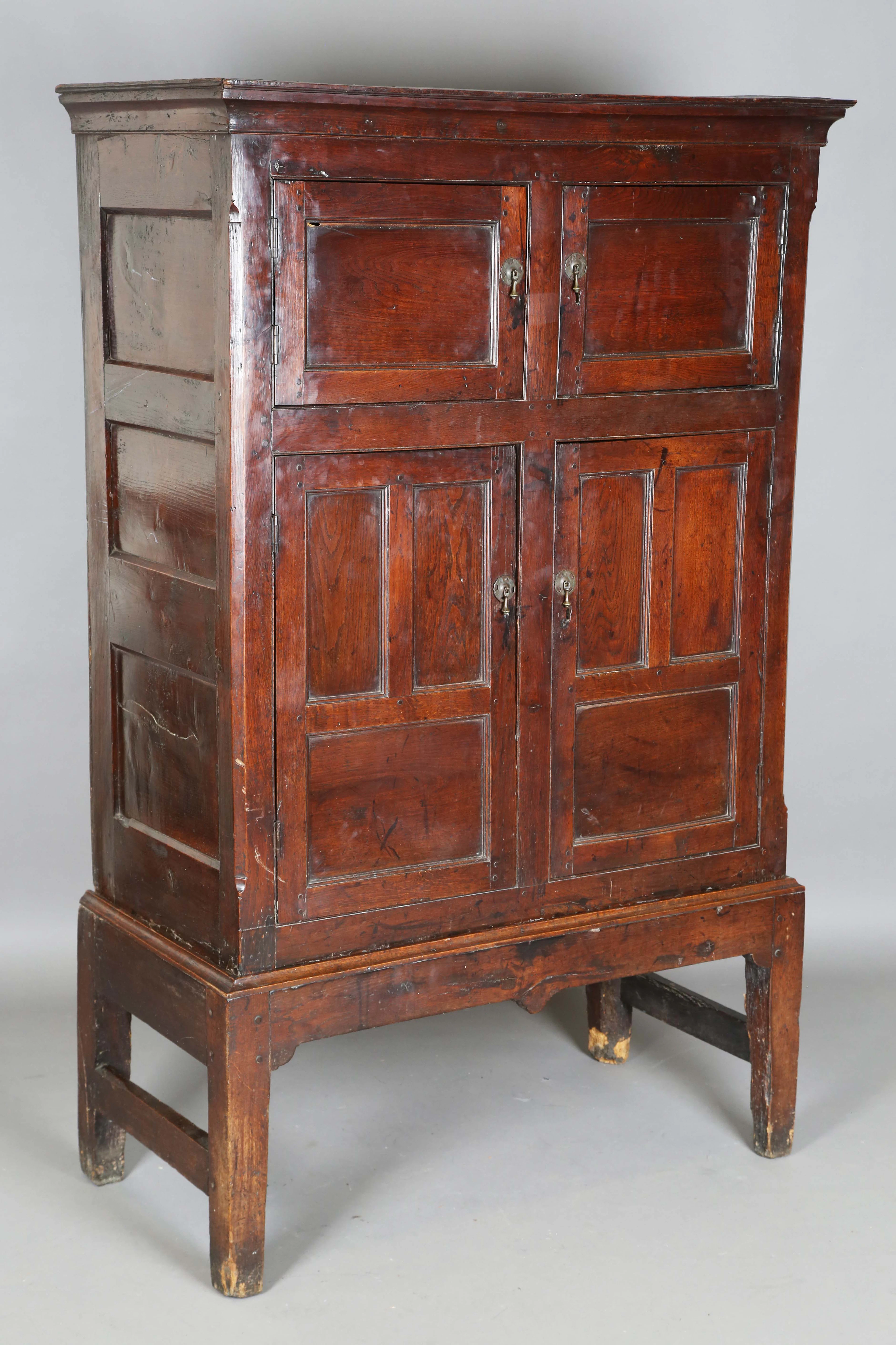 A mid-18th century provincial oak side cupboard, fitted with four