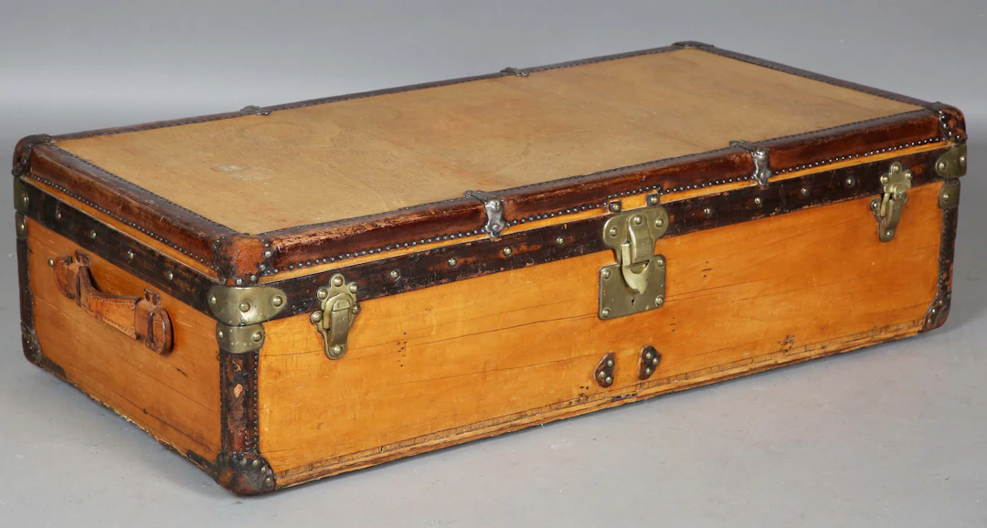An early 20th Louis Vuitton travelling trunk with brown leather bound