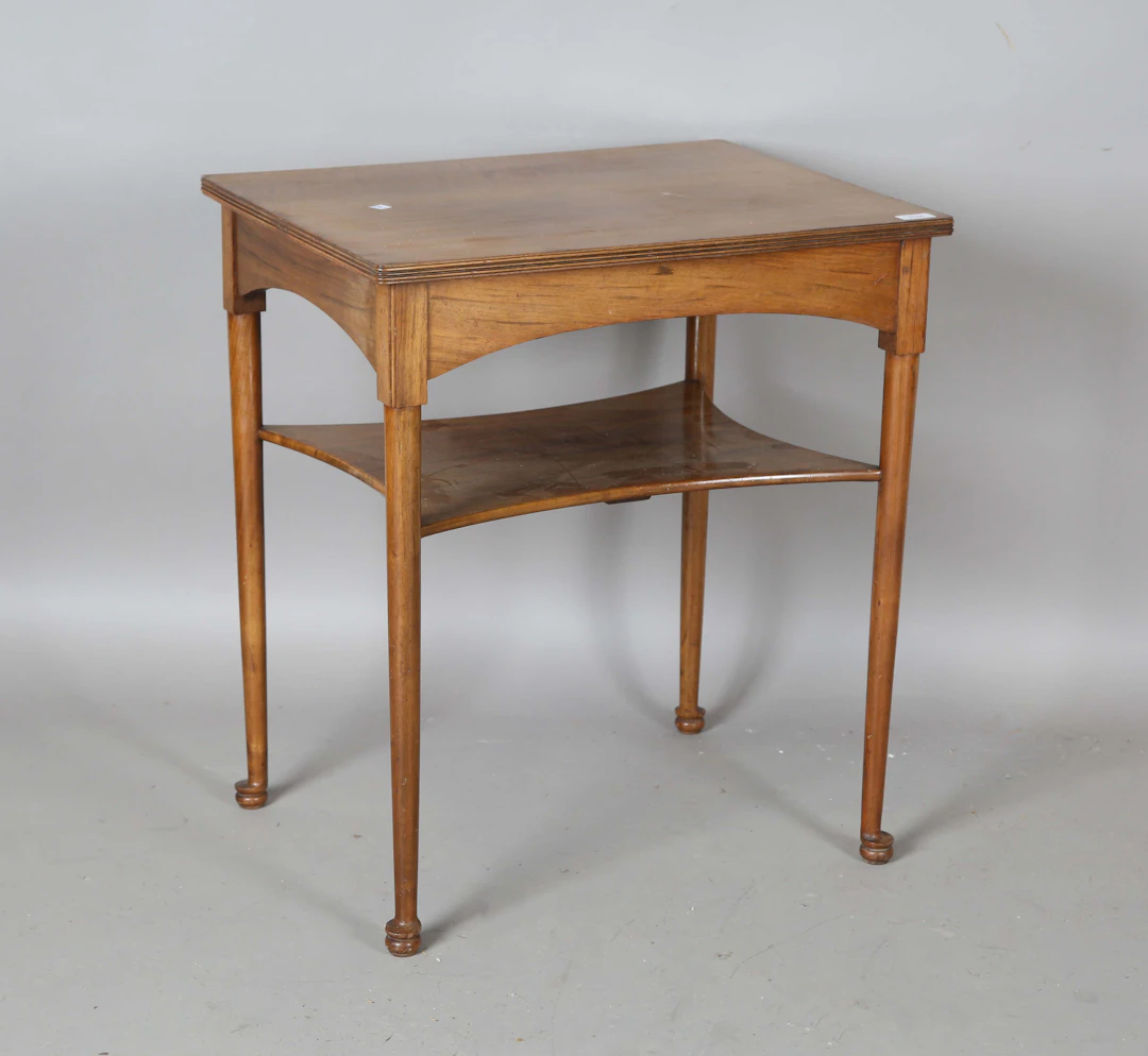 An early 20th century Arts and Crafts satin walnut two-tier occasional