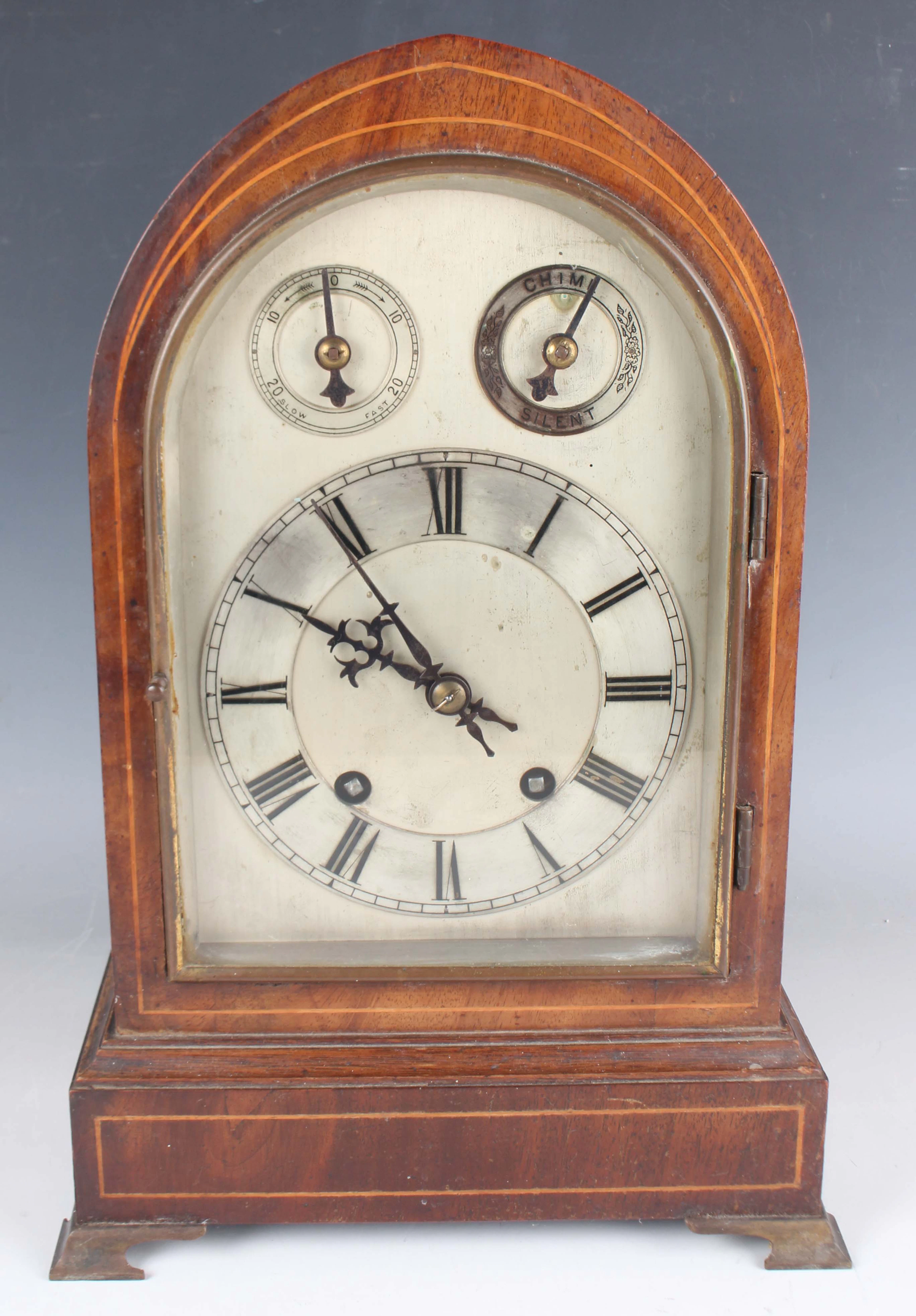 An Edwardian mahogany mantel clock with eight day movement striking