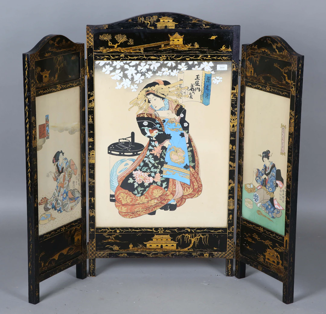 An early 20th century black and gilt decorated triptych screen, inset