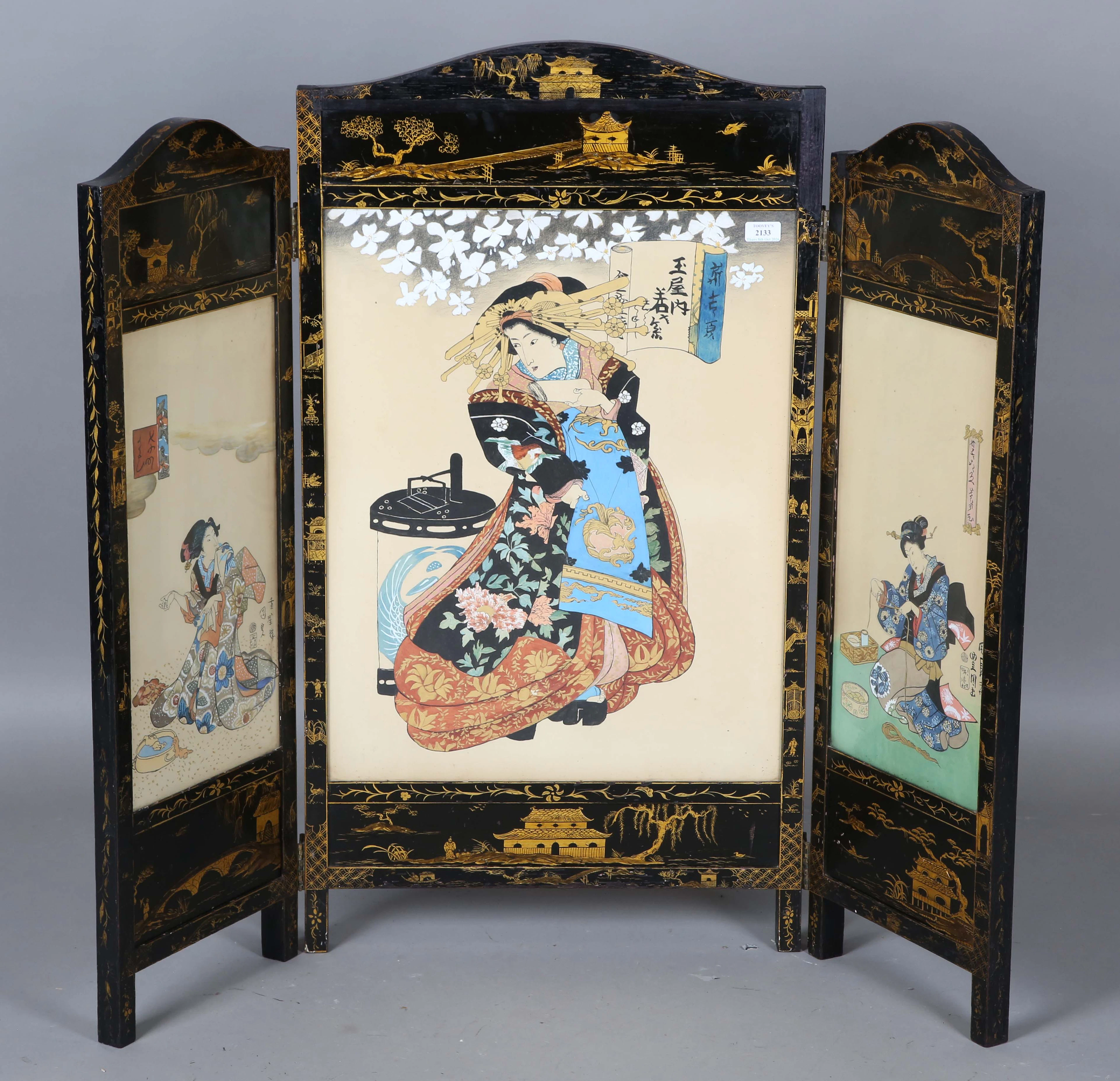 An early 20th century black and gilt decorated triptych screen, inset