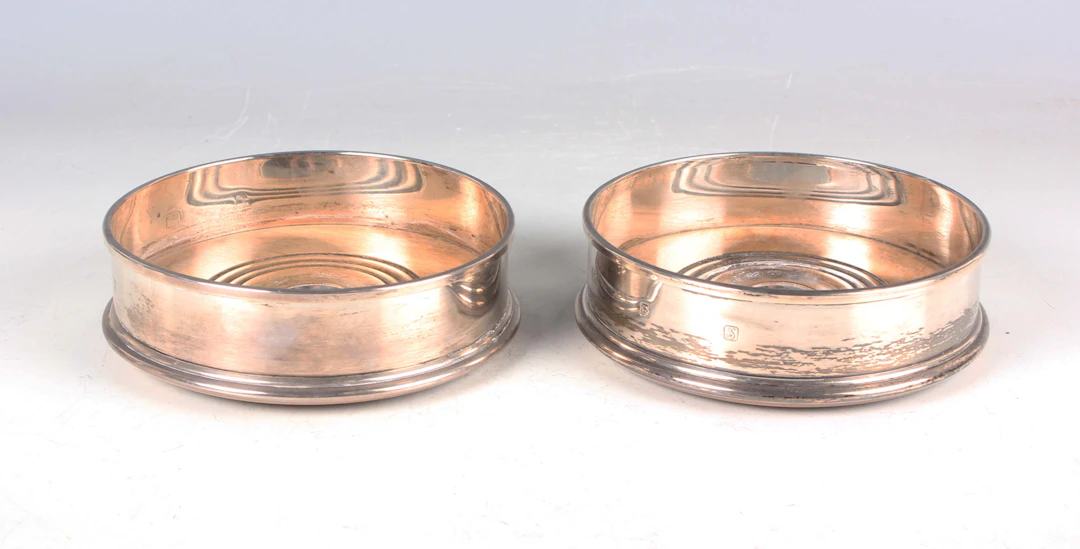 A pair of Elizabeth II silver wine coasters, London 1973 by M.C. Hersey