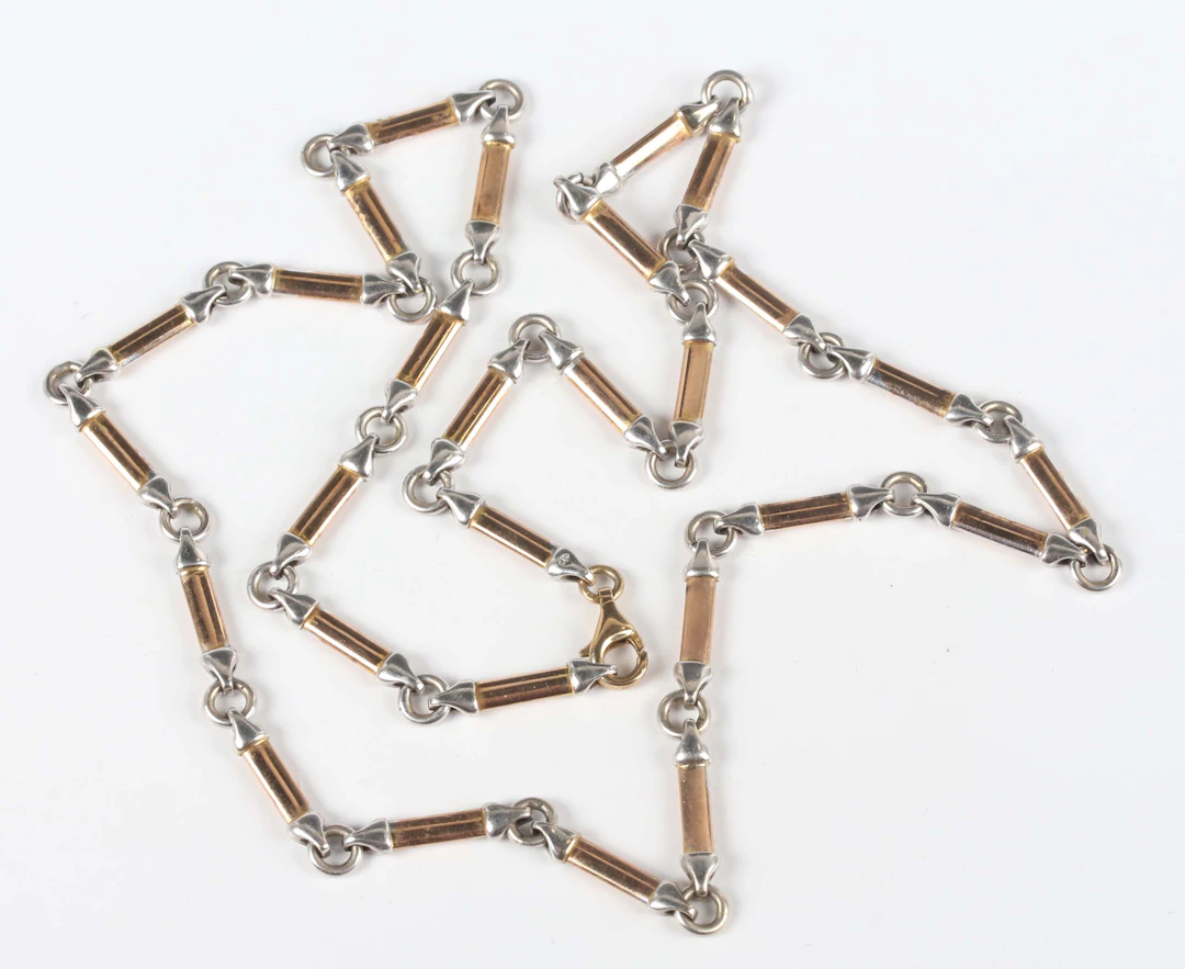 A 9ct two colour gold necklace in a baton and circular link design