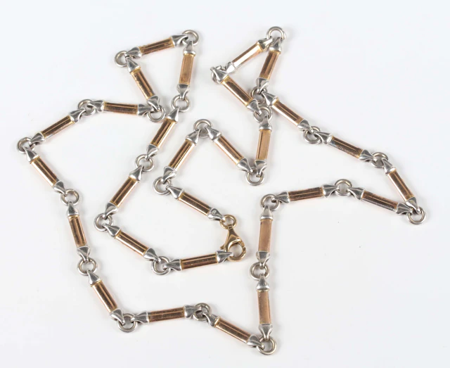 A 9ct two colour gold necklace in a baton and circular link design