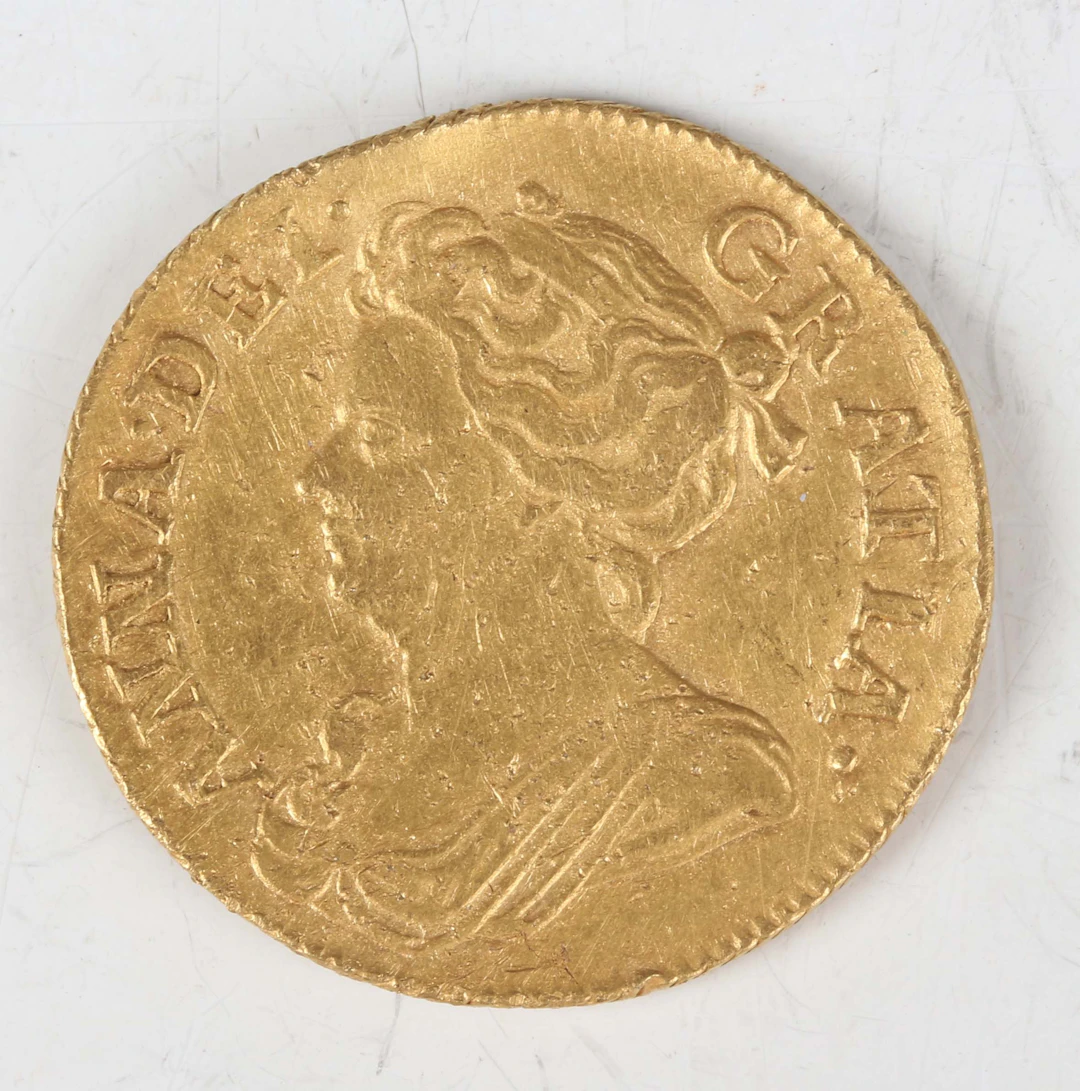 An Anne guinea 1714, third draped bust, Sp 3574 (overall poor, excavated