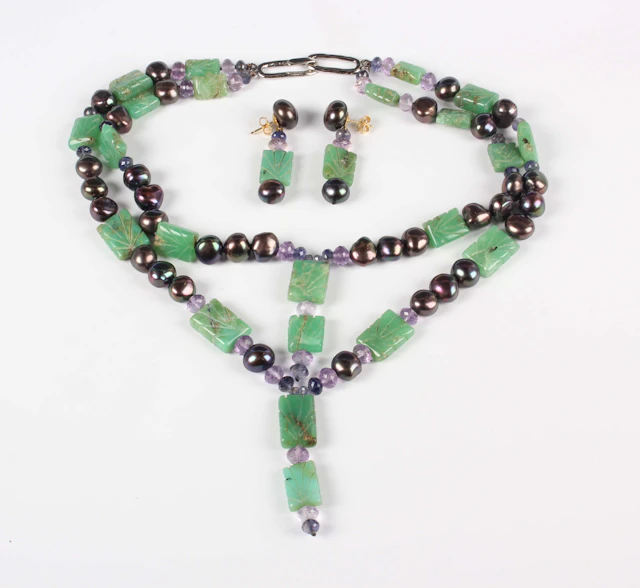 A dyed green quartz, peacock freshwater cultured pearl and faceted