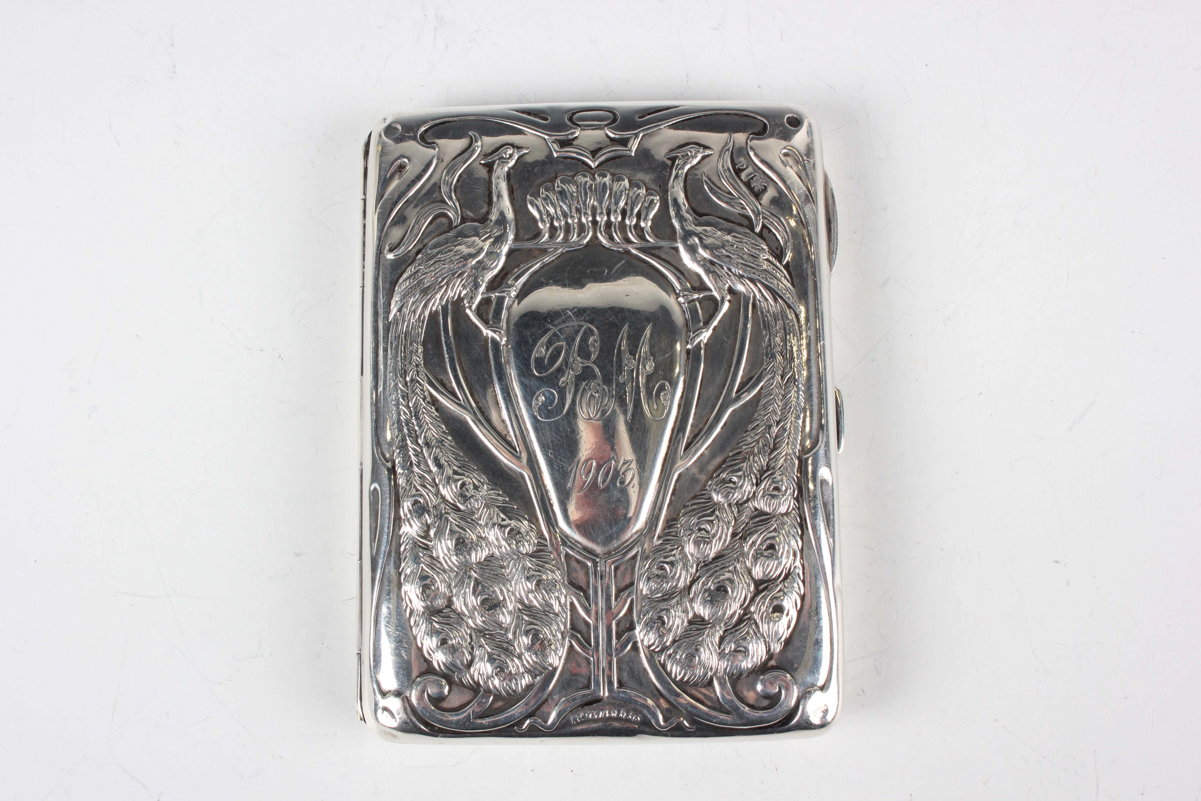 An Art Nouveau silver aide-mémoire, the front embossed with a pair