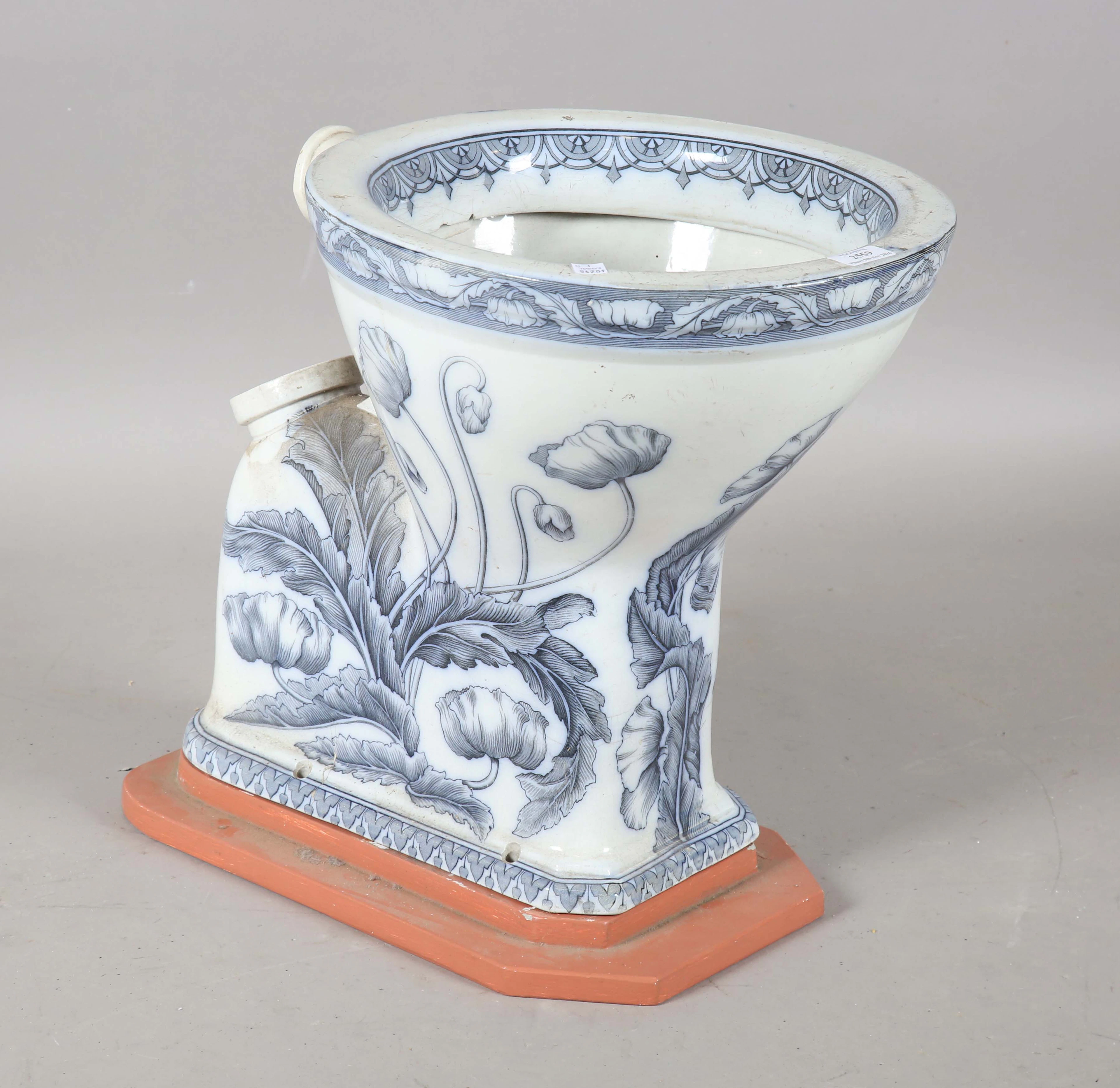 An Art Nouveau blue and white printed porcelain water closet, detailed