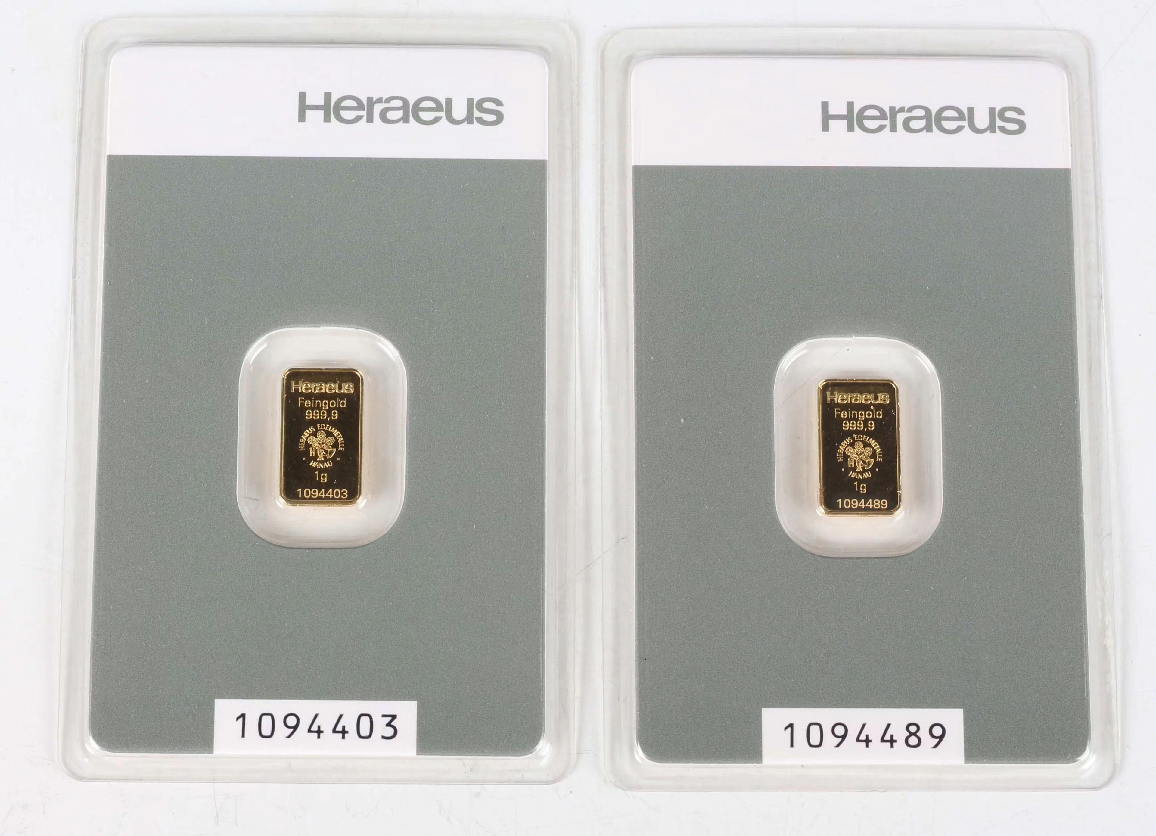 Two Switzerland Heraeus gold one gram ingots, each within a soft slab