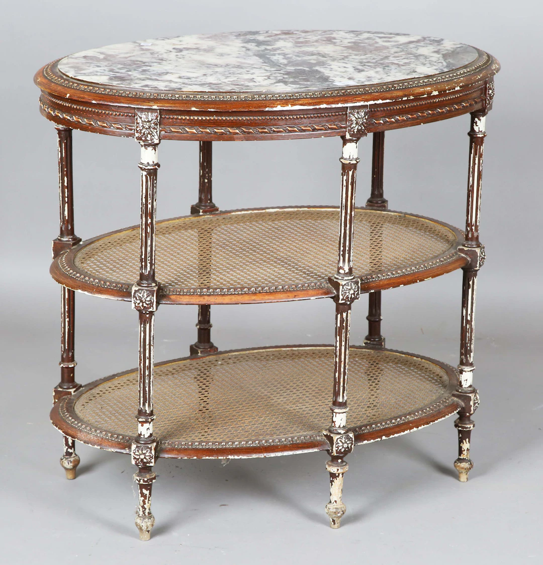 An early 20th century French painted oval three-tier étagère, the